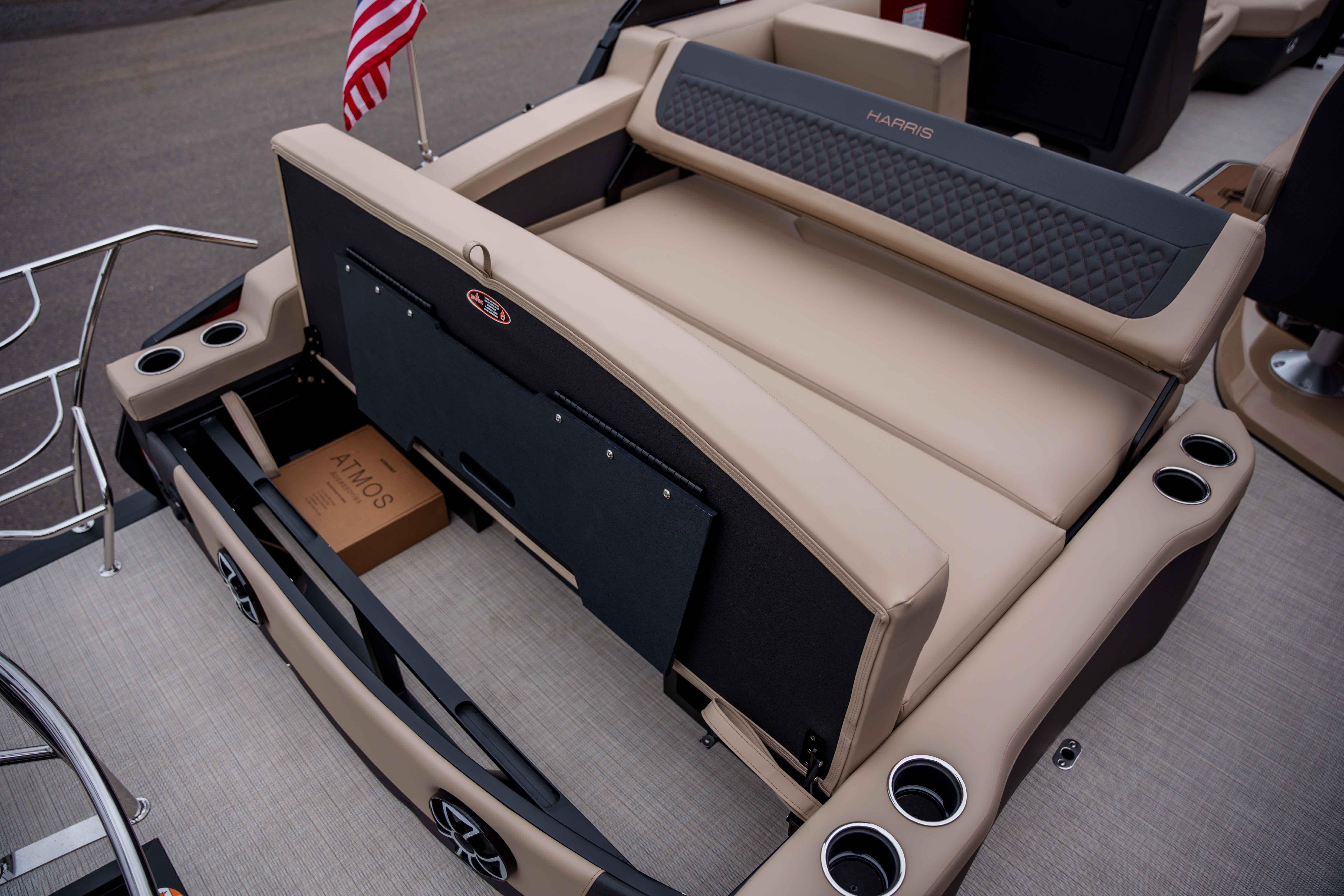 2026 Harris Sunliner 230 boat interior with beige seating and cup holders.