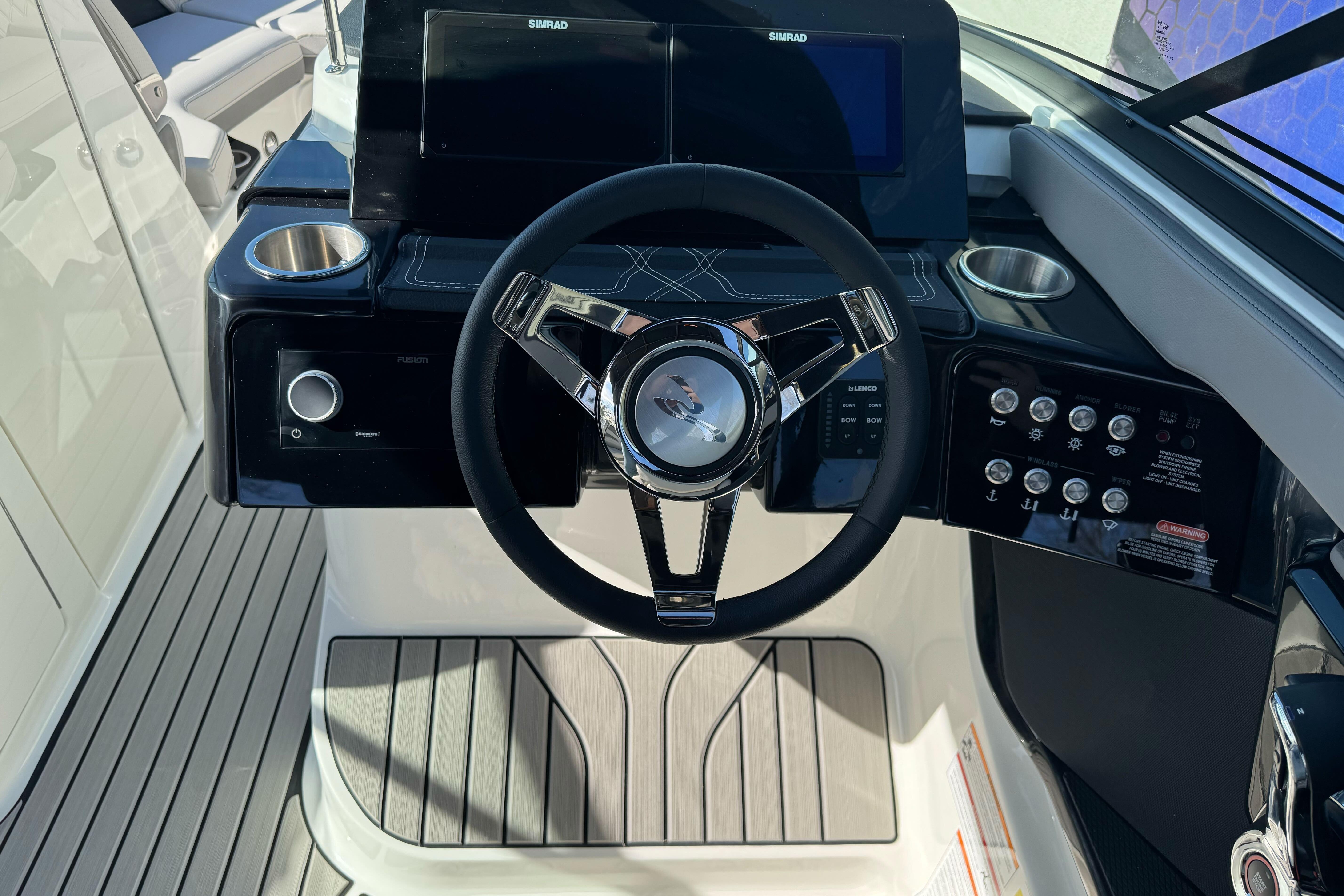 2026 Sea Ray SLX 260 helm with modern steering wheel and control panel.