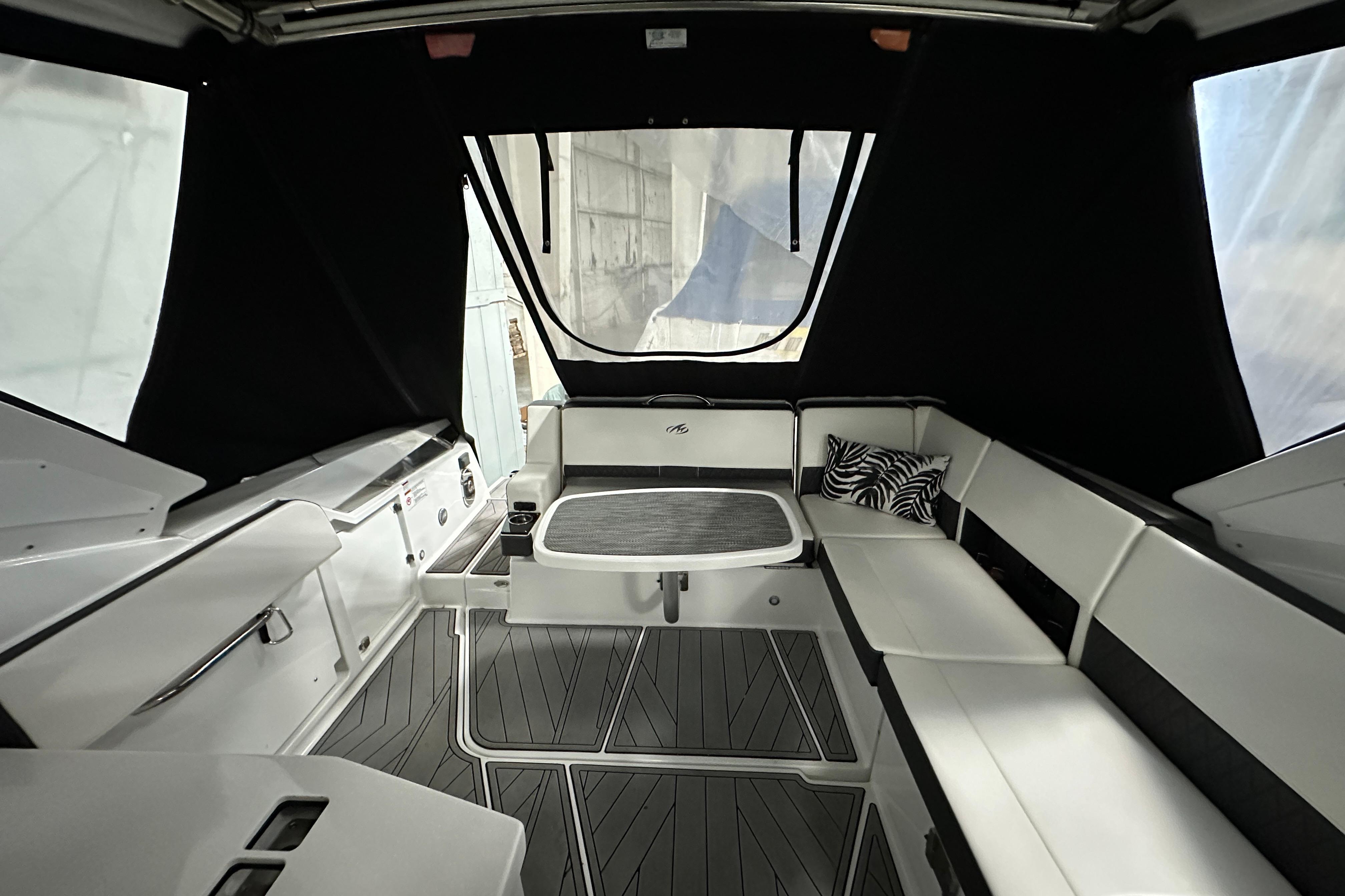 Interior of 2023 Monterey 378SS Super Sport boat with sleek seating and table.