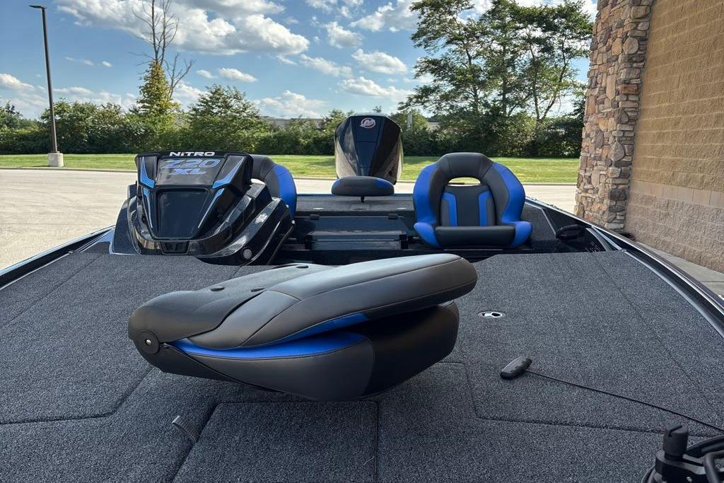2026 Nitro Z20 XL Pro boat interior with blue and black seating, parked outdoors.