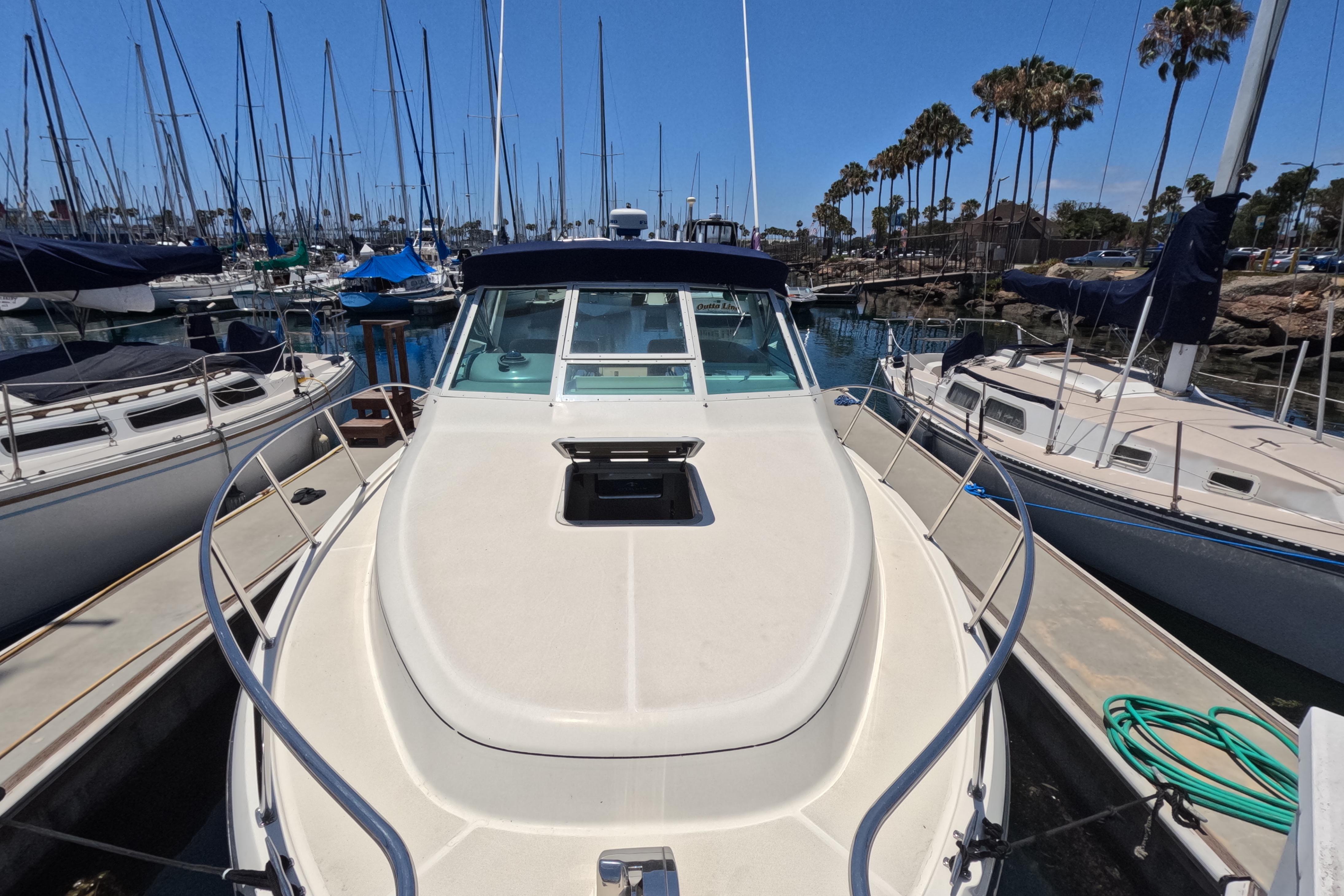 1995 Tiara Yachts 2900 Open docked in a marina with sailboats.