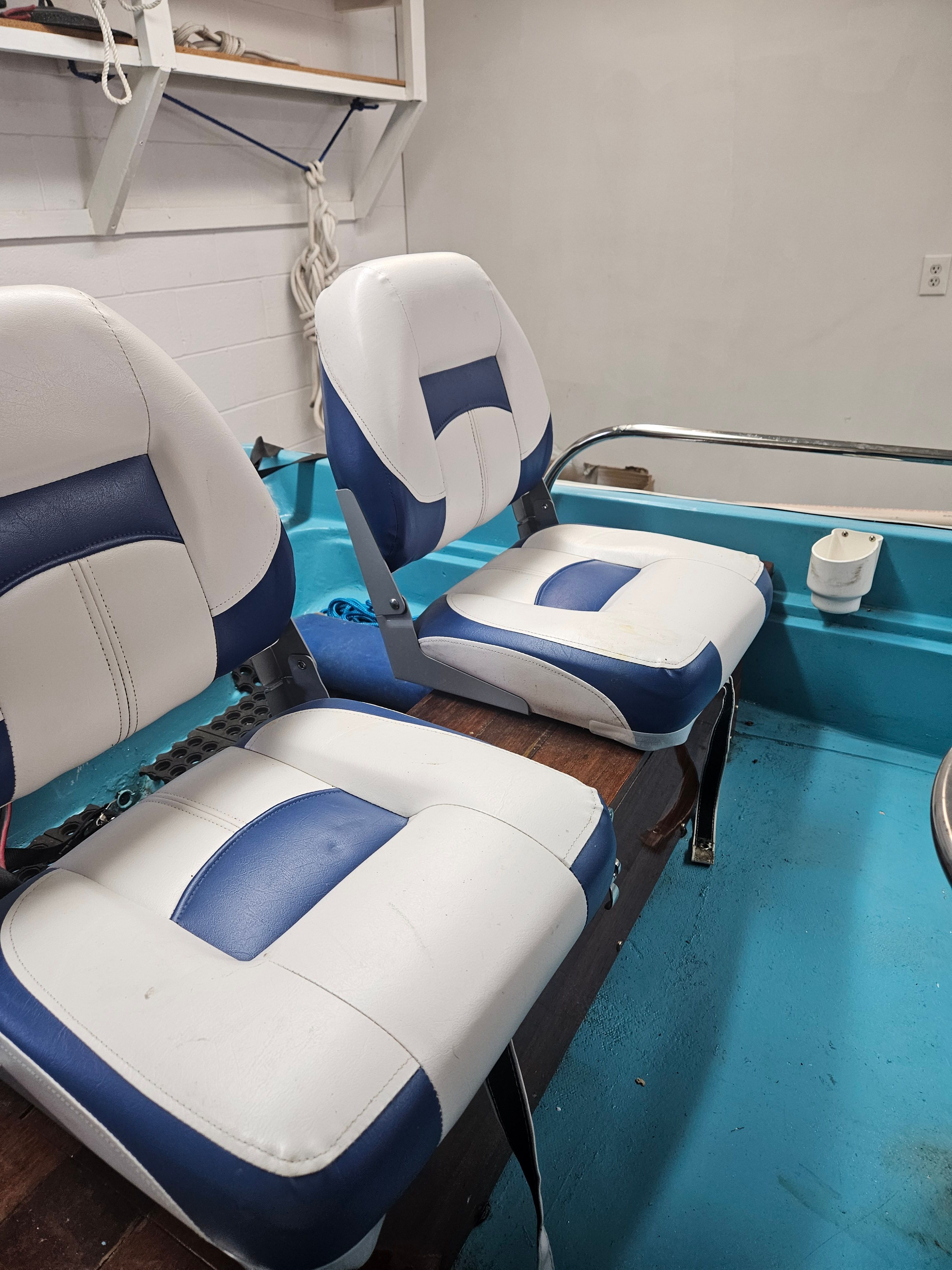 Interior of a 1977 Boston Whaler 14 with blue and white seats.