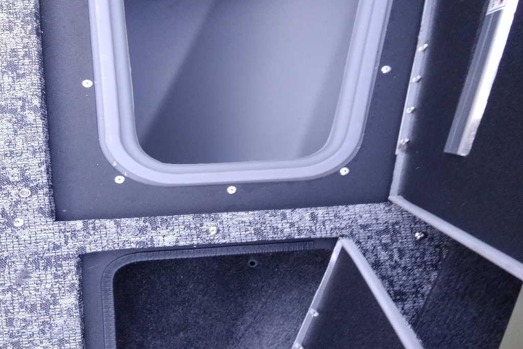 Interior compartments of 2026 Tracker Targa V-19 Combo boat, featuring storage spaces.