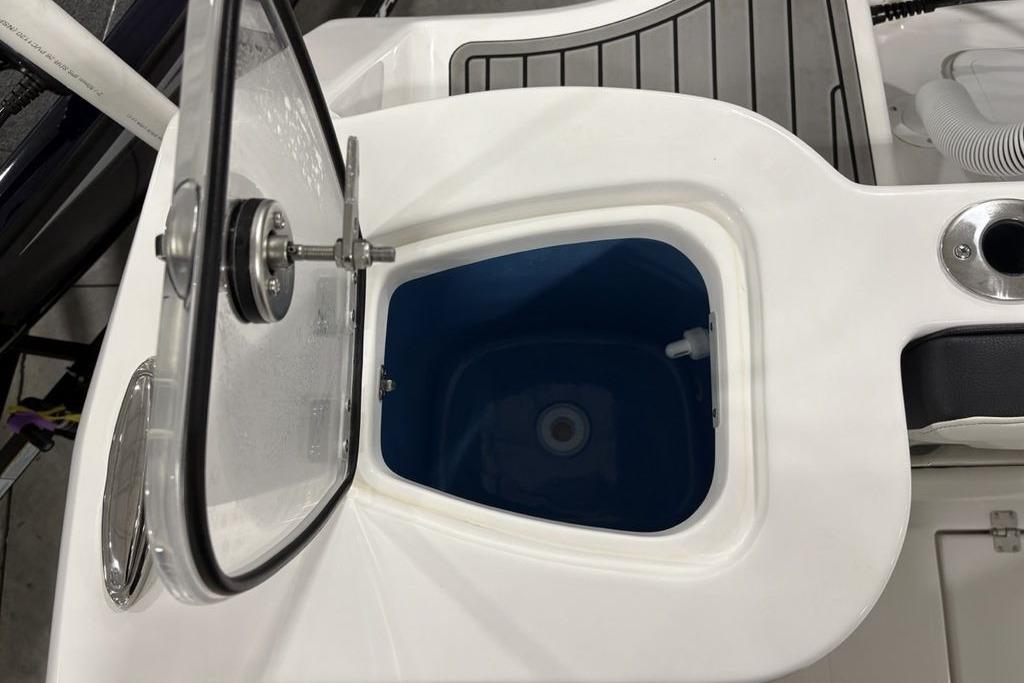 Open storage compartment on 2026 Tidewater 232 CC Adventure boat.