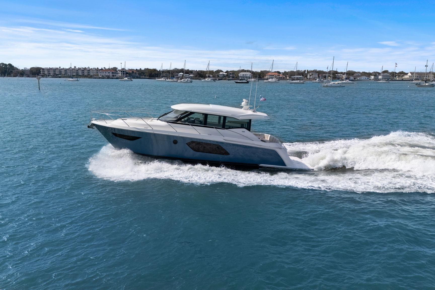 2023 Tiara Yachts C49 Coupe cruising on blue waters under clear skies.