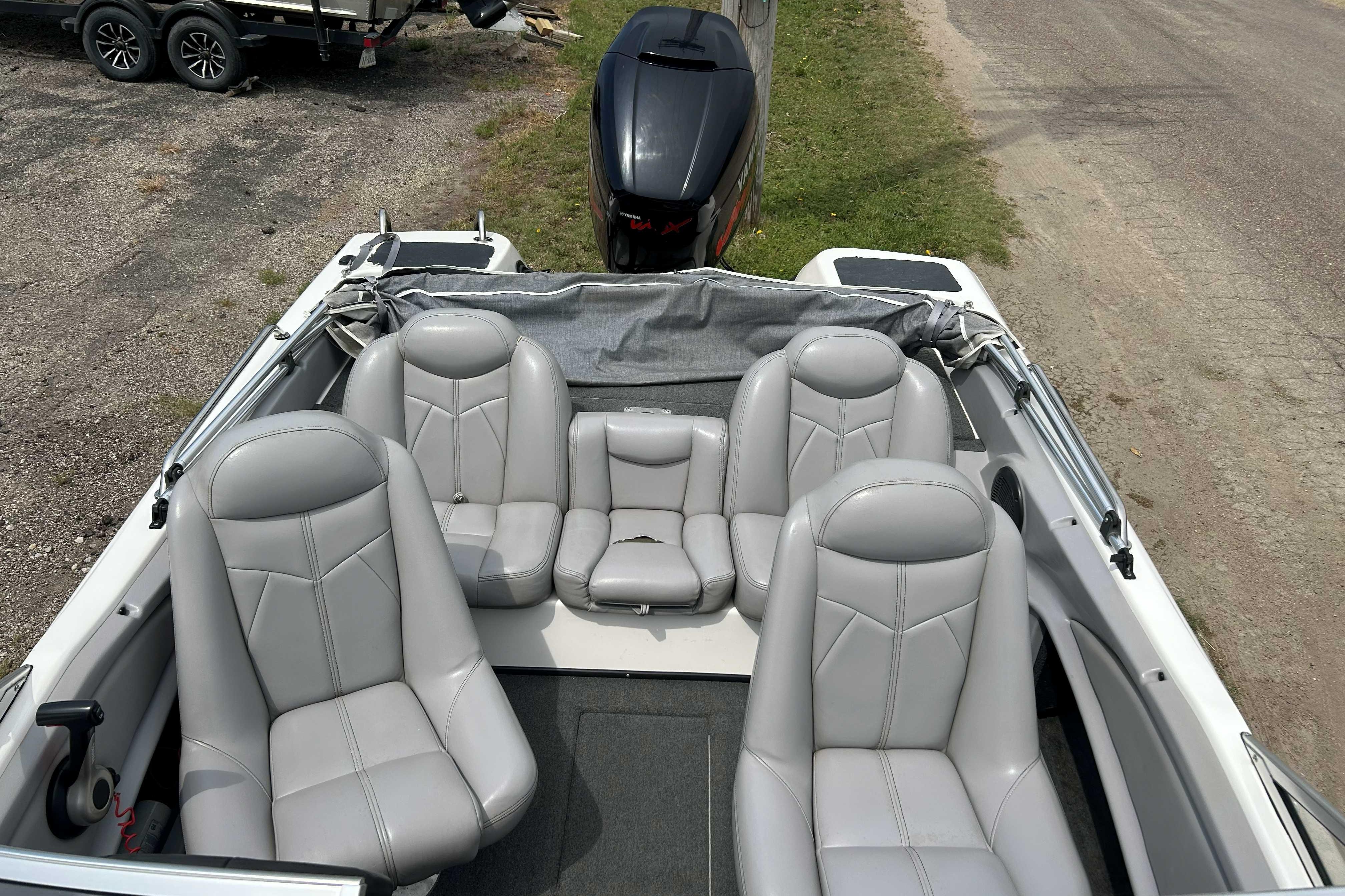 2010 Skeeter SL 180 boat interior with gray leather seats and outboard motor.