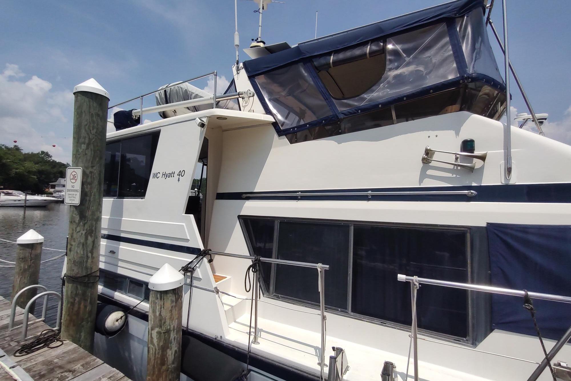 1989 Hyatt Double Cabin Motoryacht docked at marina under clear sky.