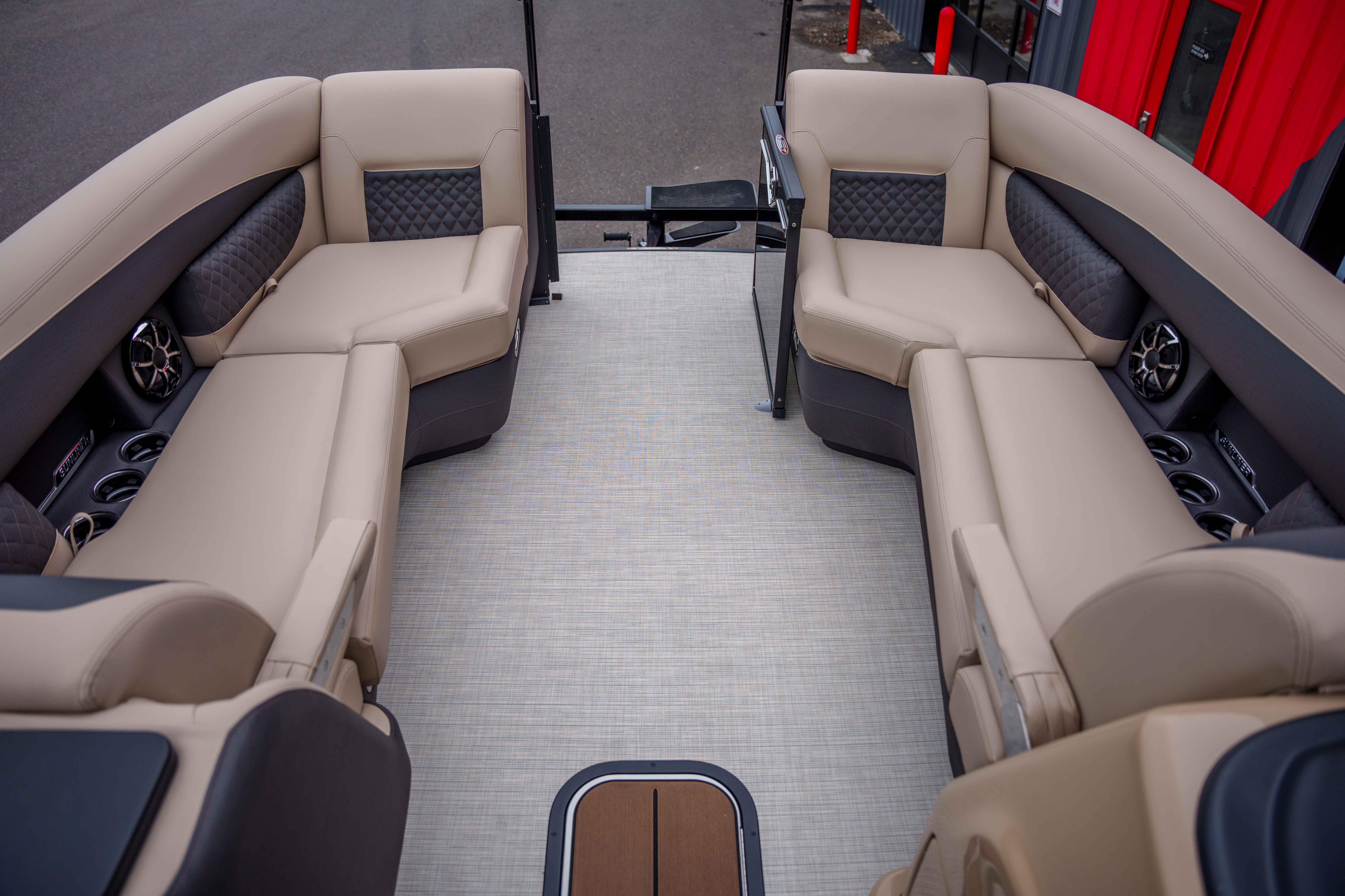 Luxurious interior of 2026 Harris Sunliner 230 pontoon boat with beige seating.