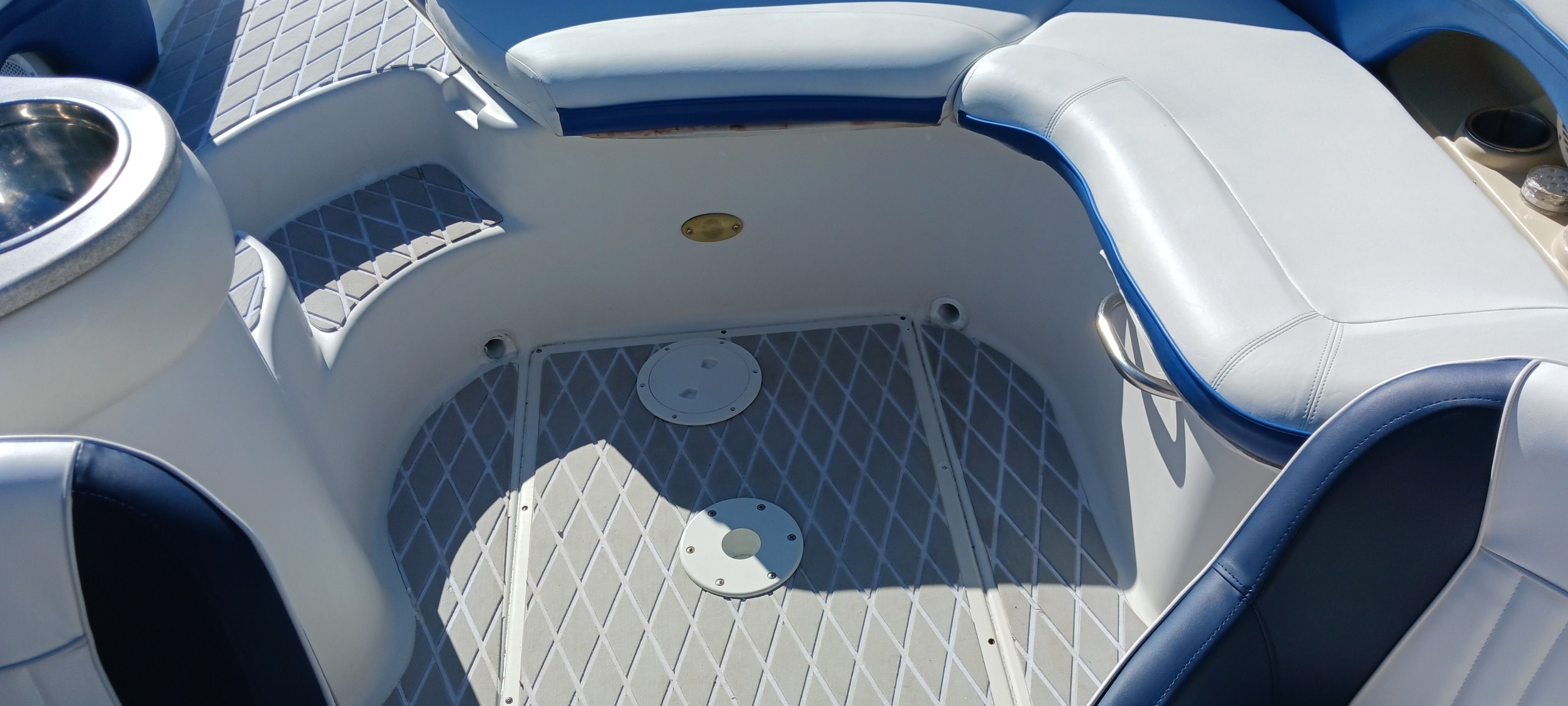 Interior of 2003 Four Winns 205 Sundowner boat with cushioned seating and non-slip flooring.