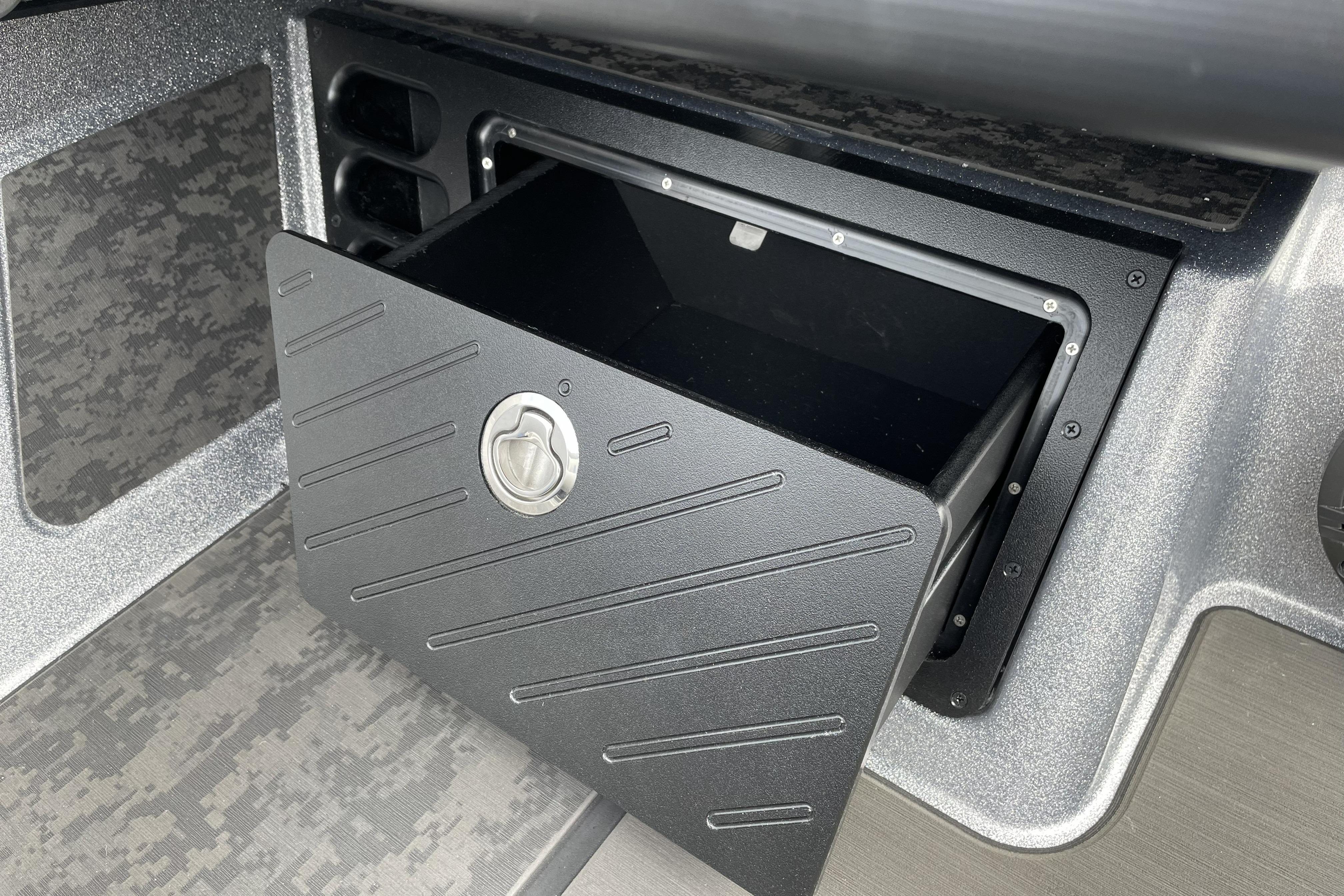 Open storage compartment in 2026 Nitro Z21 XL boat interior.