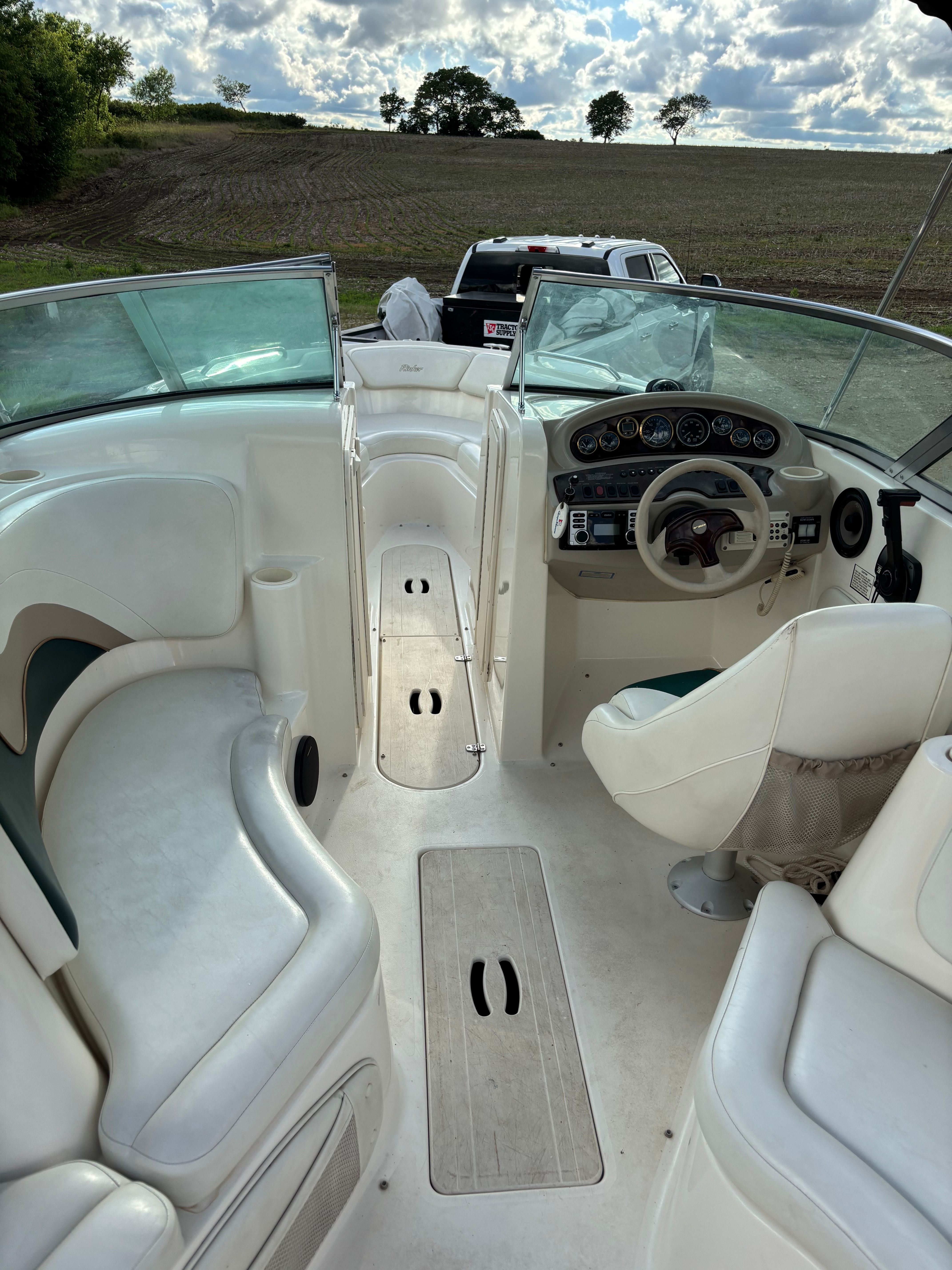 Interior of a 1999 Rinker Captiva 272 boat on a field.