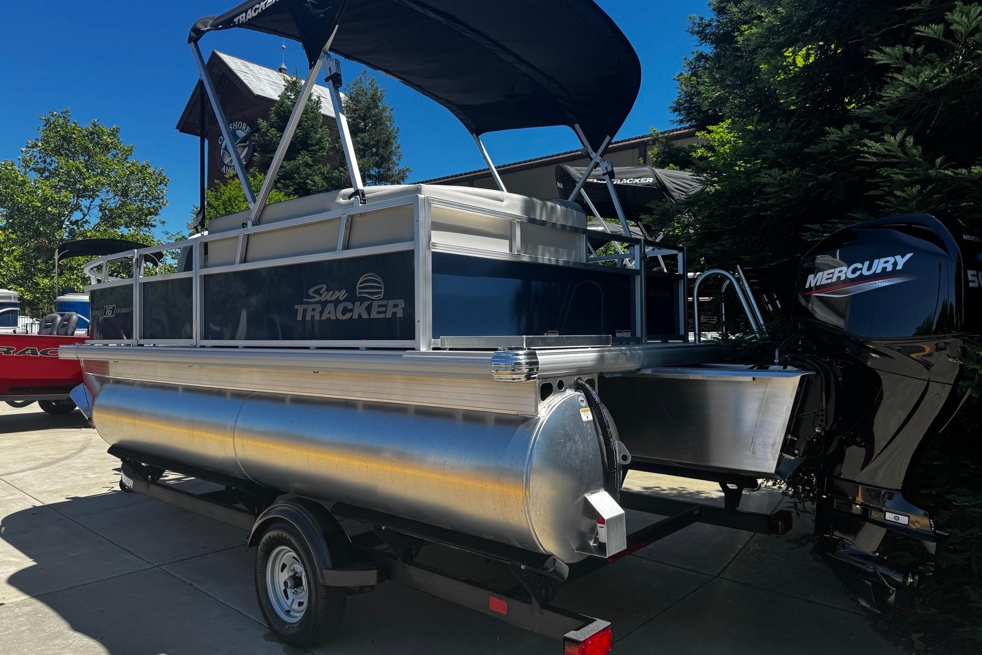 2026 Sun Tracker Bass Buggy 16 XL Select pontoon boat with Mercury engine on trailer.