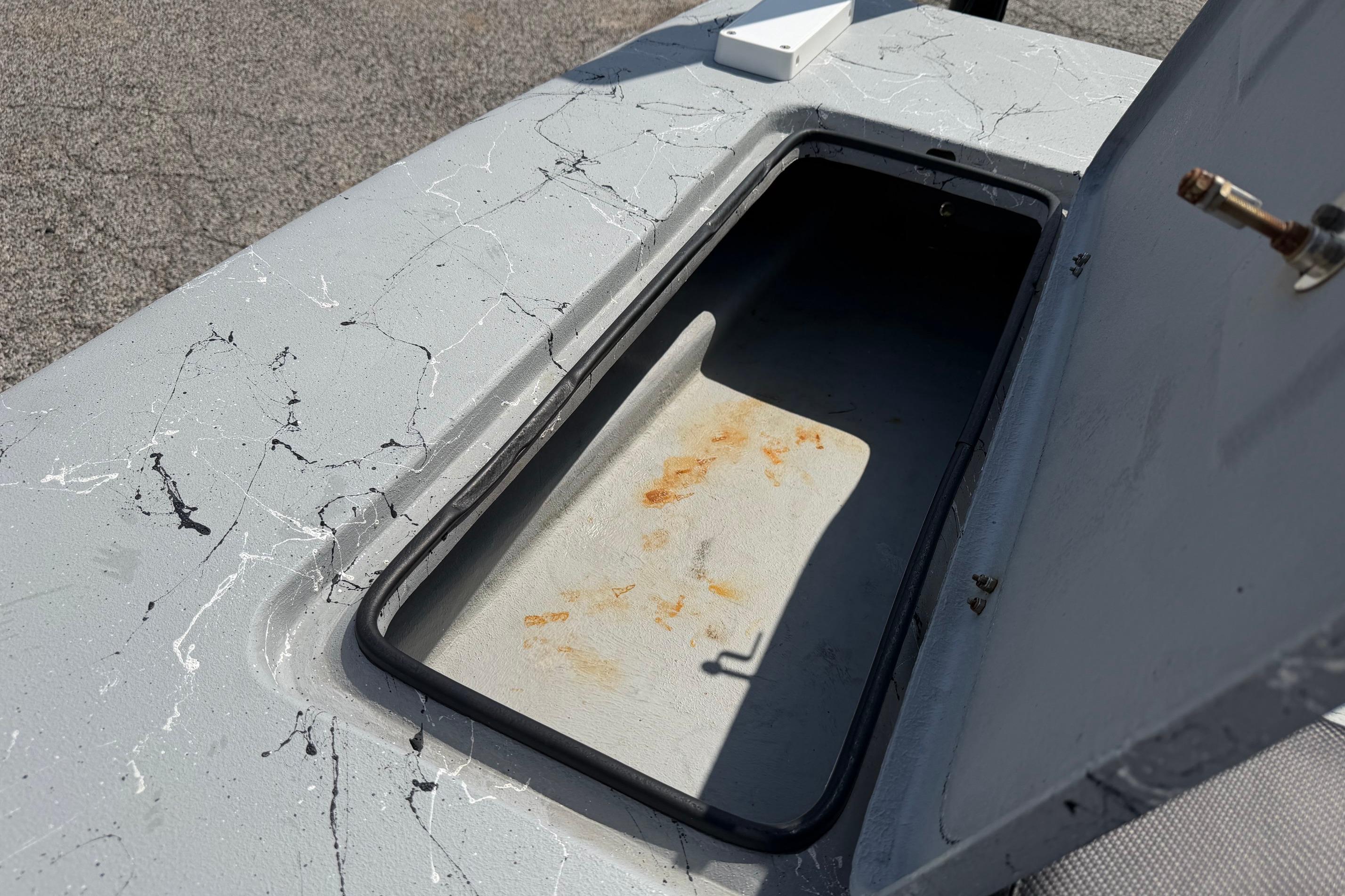 Open storage compartment on 2023 Haynie 23 Super Cat boat, showing interior details.