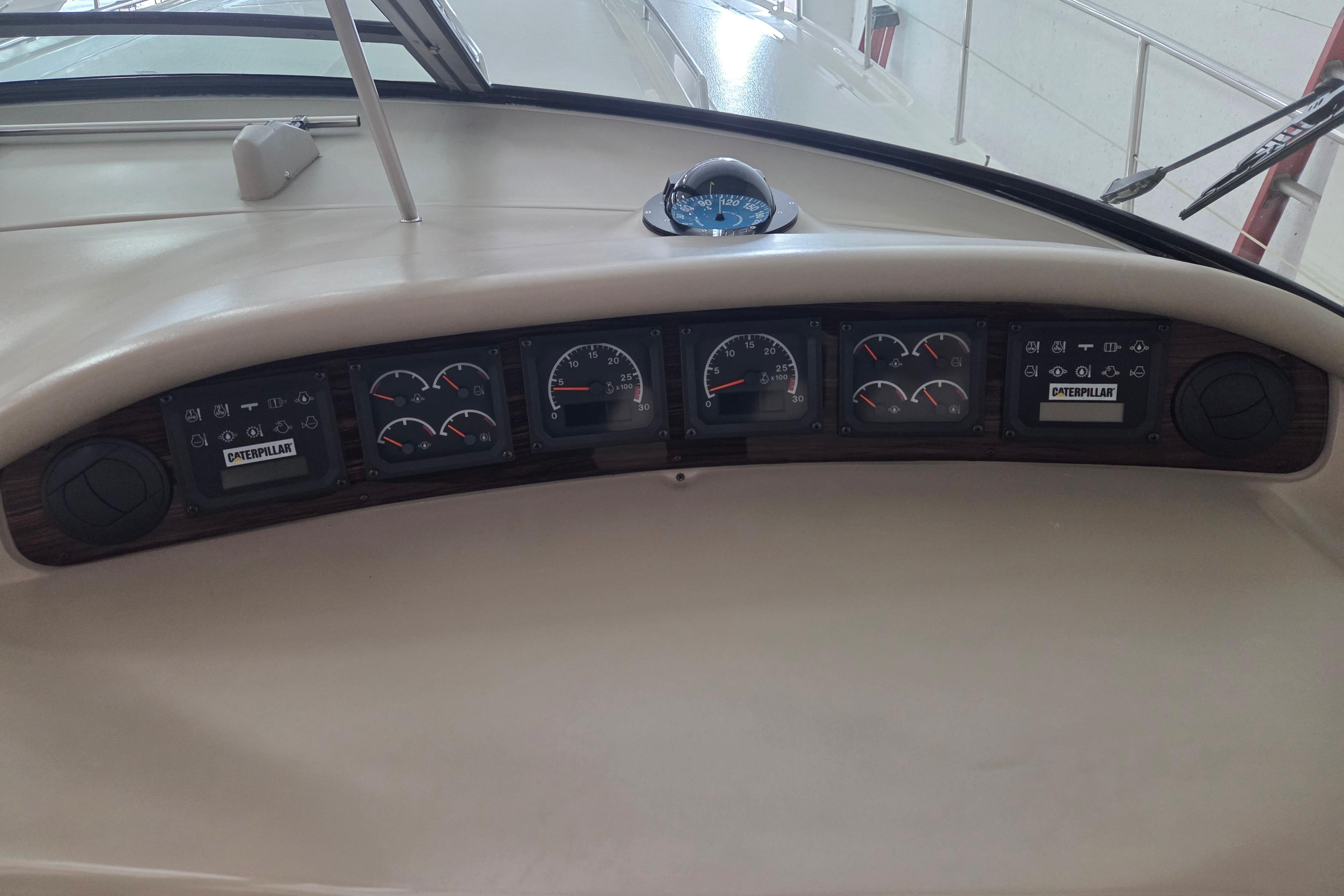 Dashboard of a 2000 Sea Ray Sundancer 540 boat with gauges and controls.