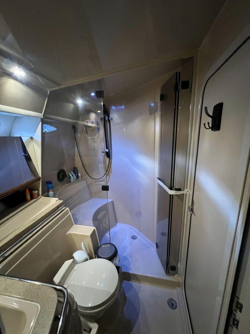 Bathroom interior of 2000 Cruisers Yachts 4270 Express, featuring shower and toilet.