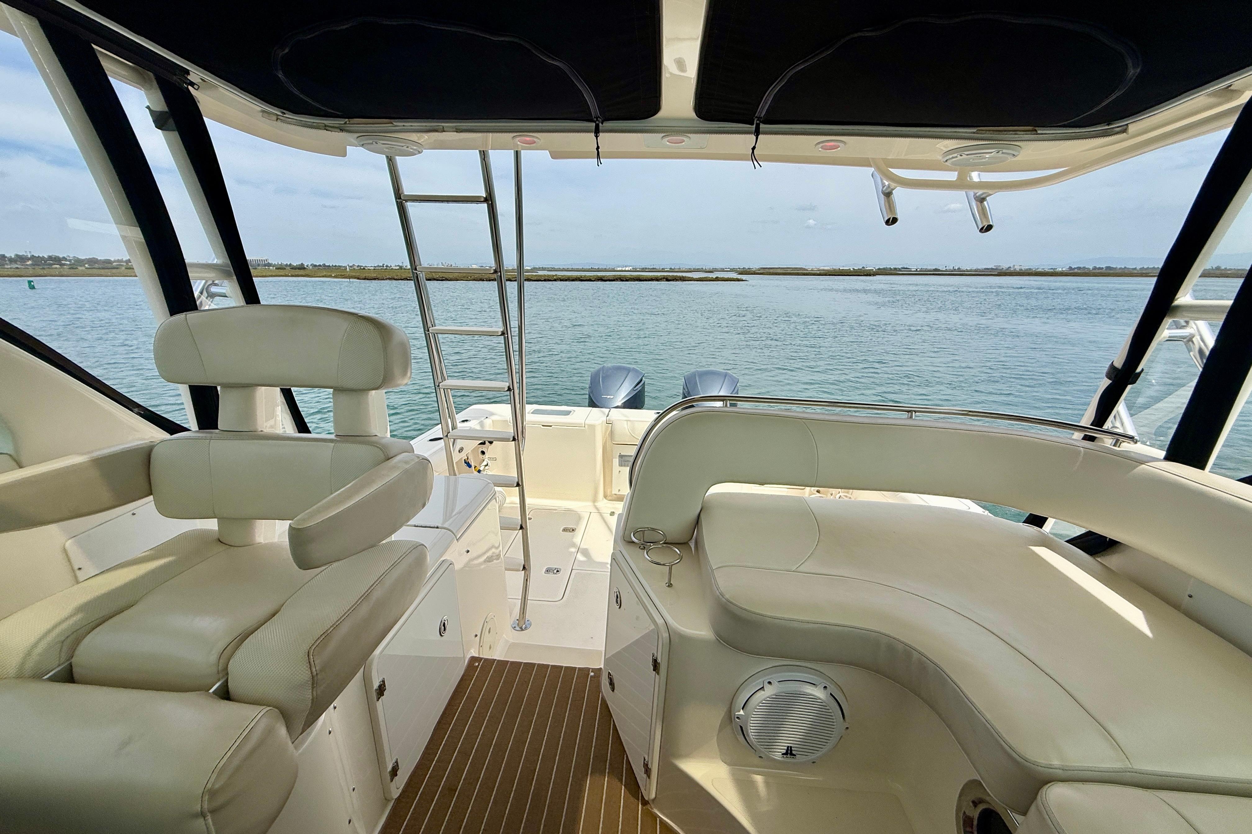 Interior view of 2012 Pursuit OS 345 Offshore boat with seating and ocean backdrop.