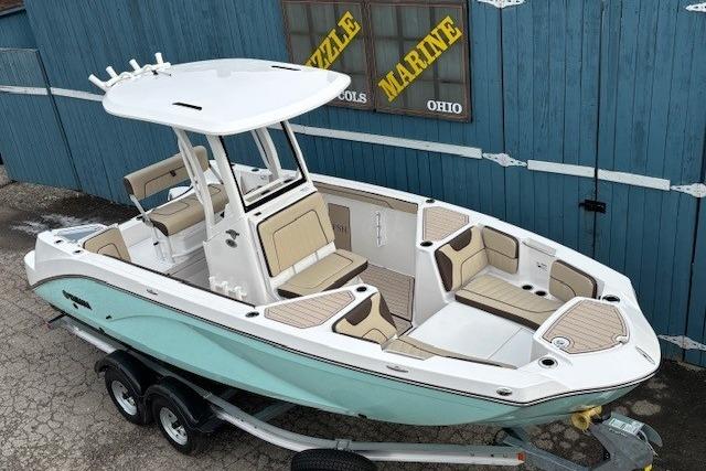 2026 Yamaha Boats 222 FSH Sport E, sleek design, dual console, on trailer, blue and white exterior.