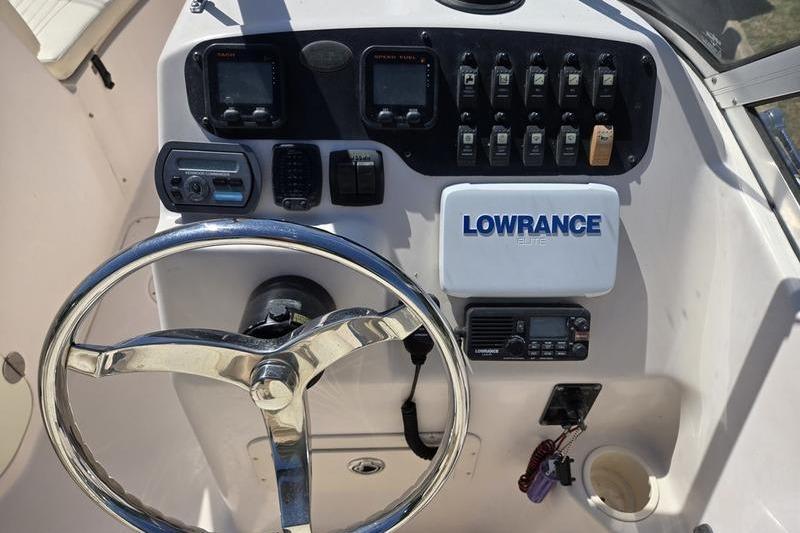 Dashboard of a 2007 Grady-White Tournament 205 boat with steering wheel and Lowrance electronics.