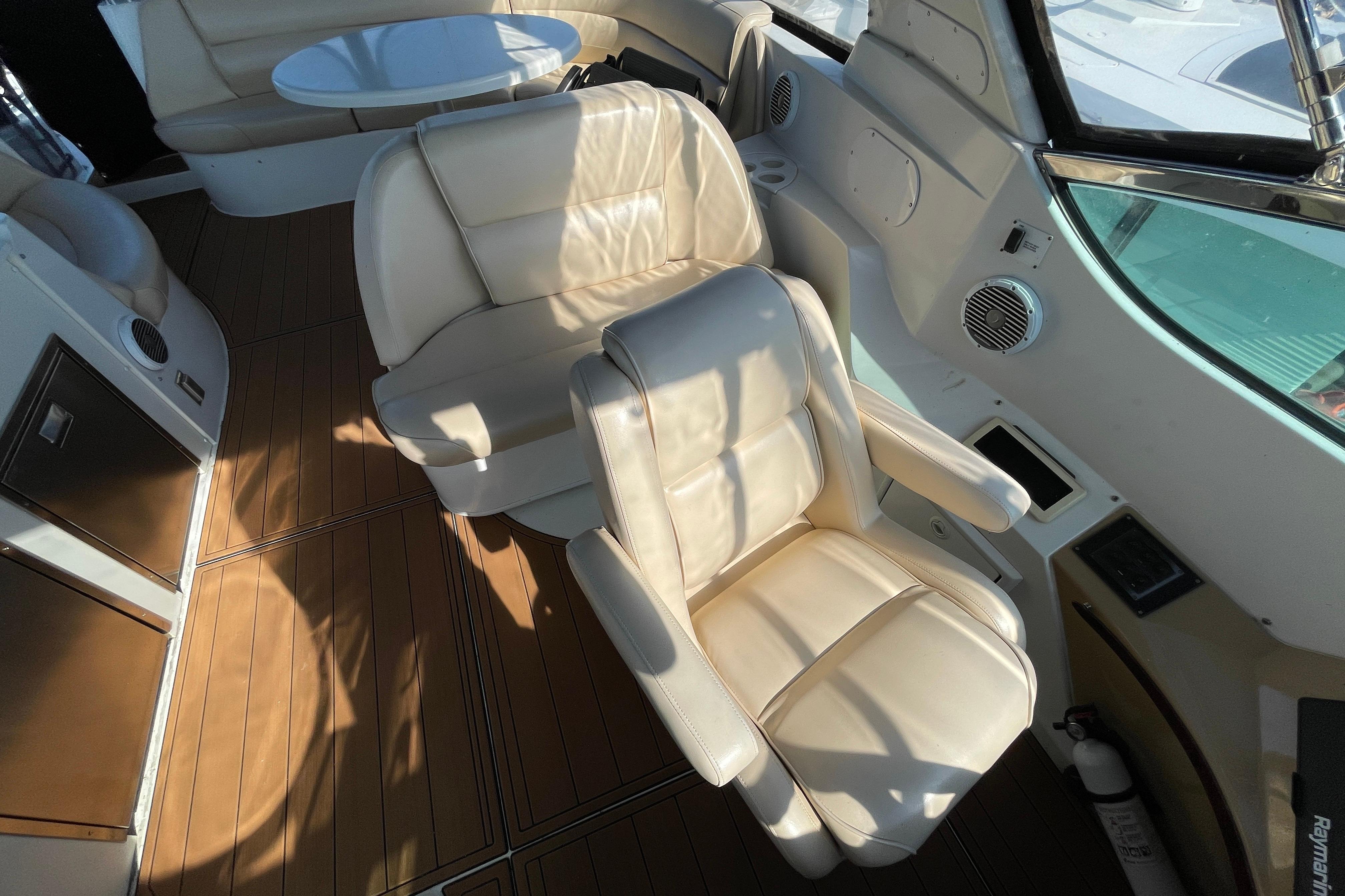 Luxurious interior of 2002 Carver 570 Voyager Pilothouse with leather seating and wood flooring.