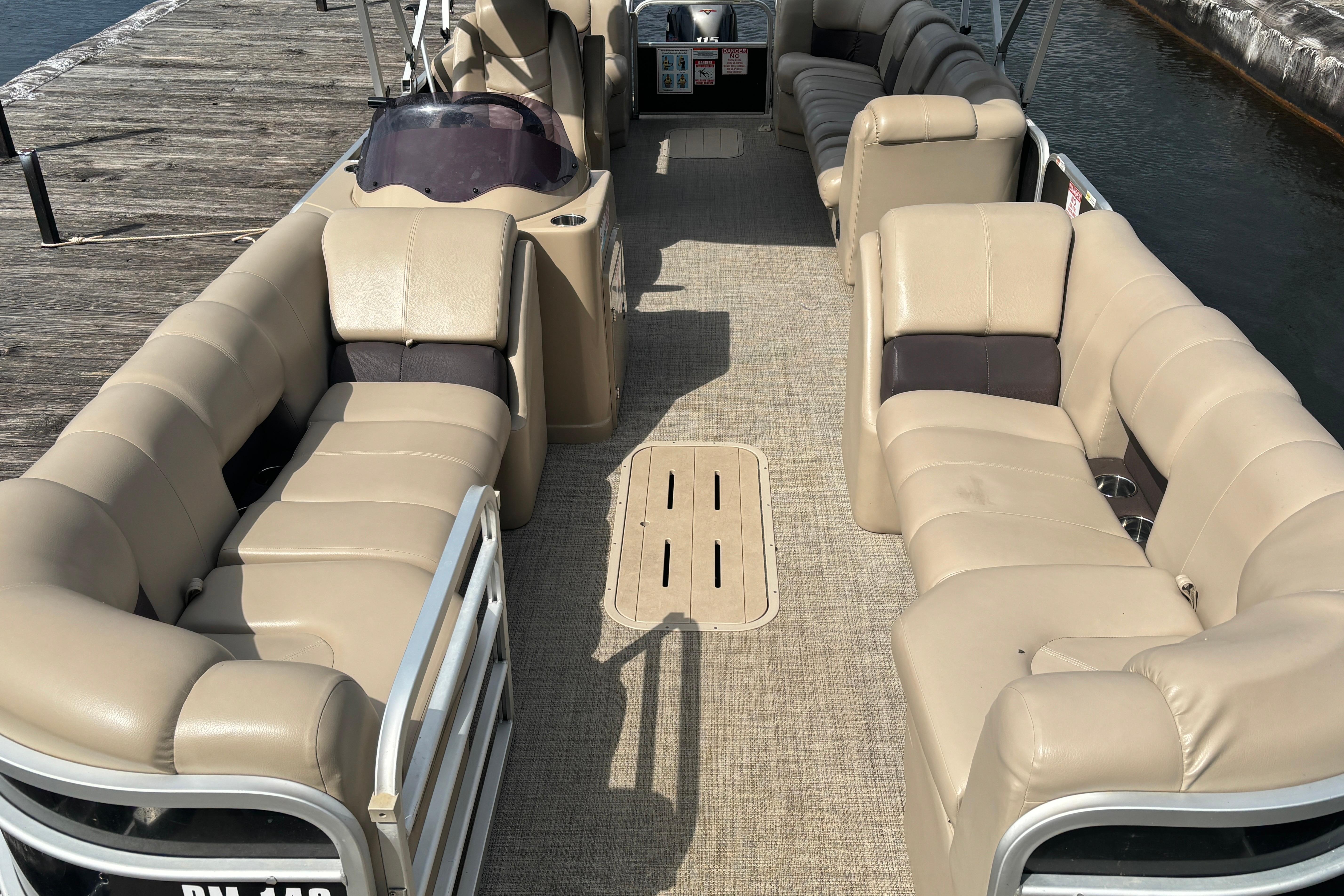 2021 SunCatcher Fusion 325RCX pontoon boat with spacious beige seating and sleek design.