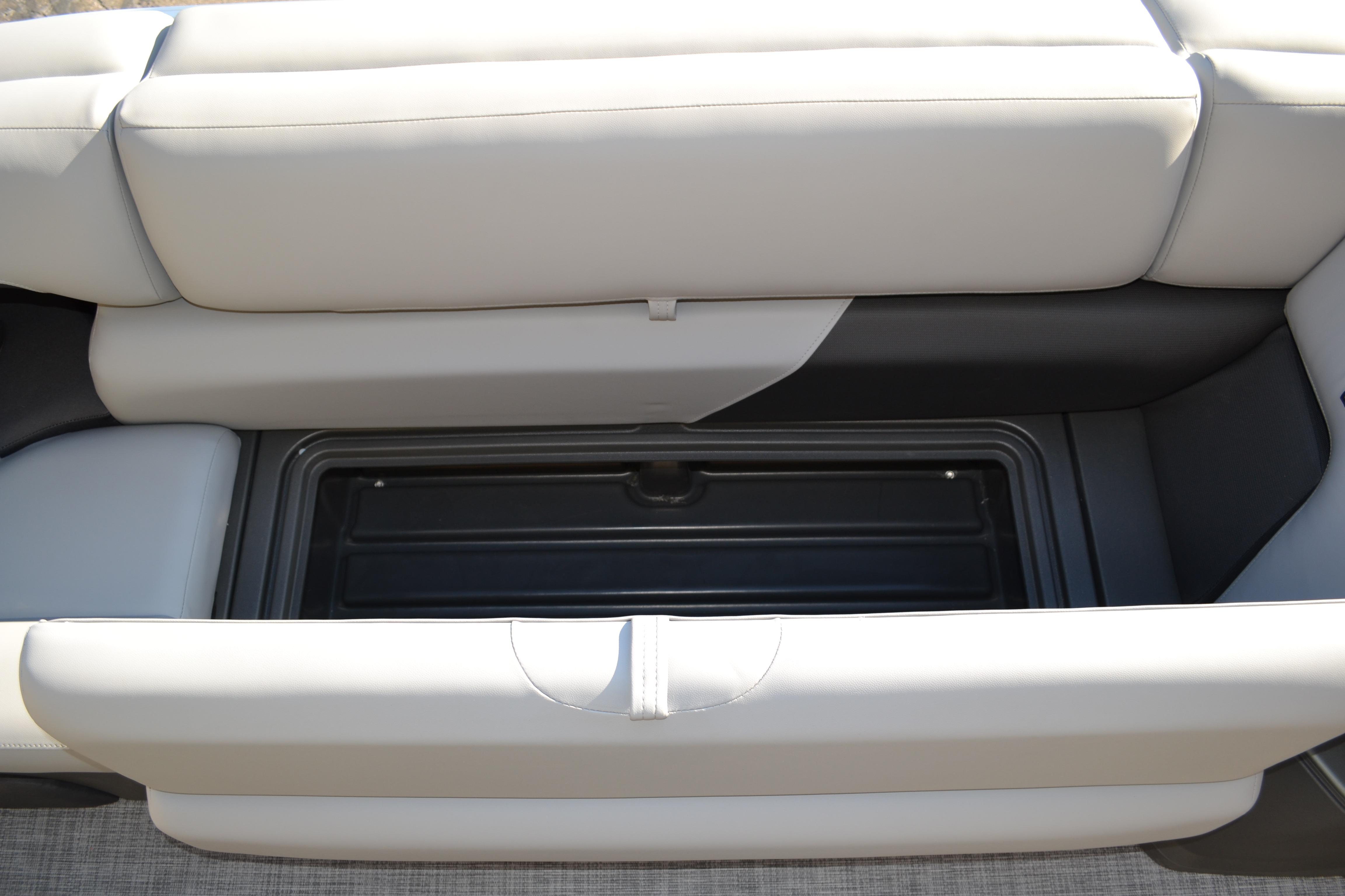 2026 Sun Tracker SportFish 22 XP3 boat seat storage compartment, open and empty.