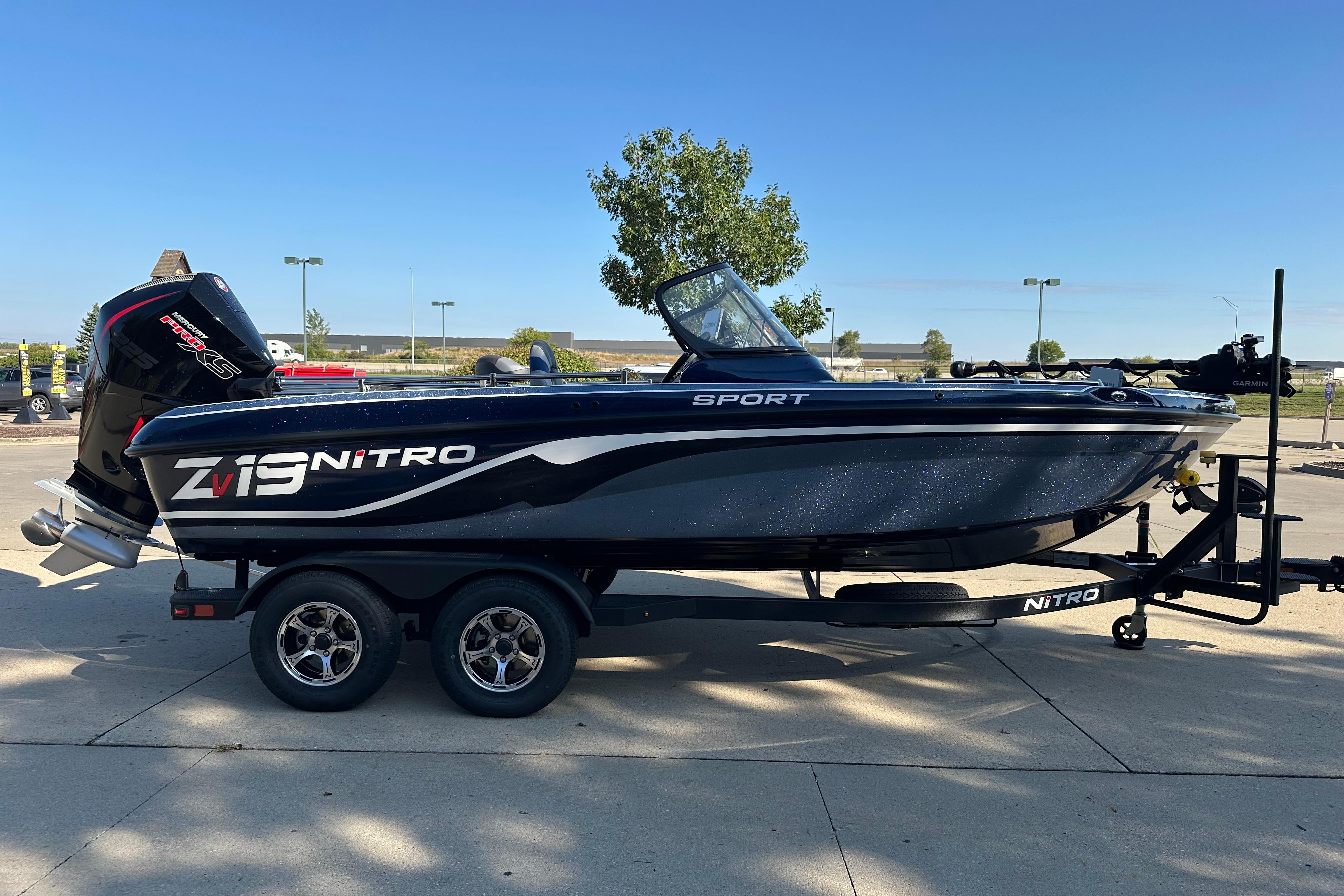 2026 Nitro ZV19 Sport Pro boat on trailer, parked outdoors under clear sky.