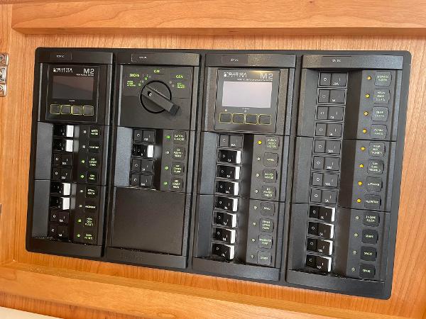 Back Cove 34O 2024 electrical control panel with multiple switches and digital displays.