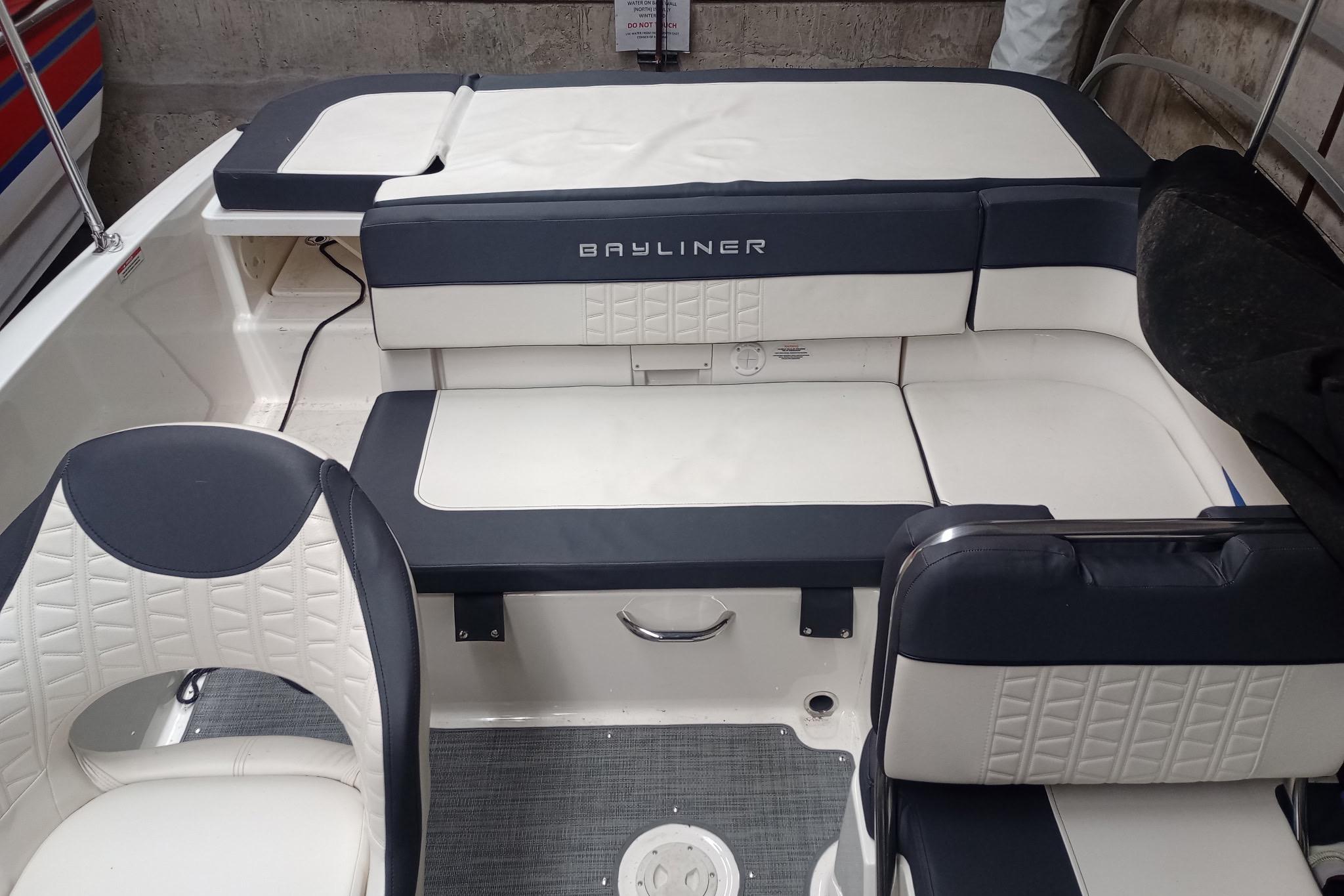 2022 Bayliner VR5 Bowrider I/O interior with white and navy seating, showcasing modern design.