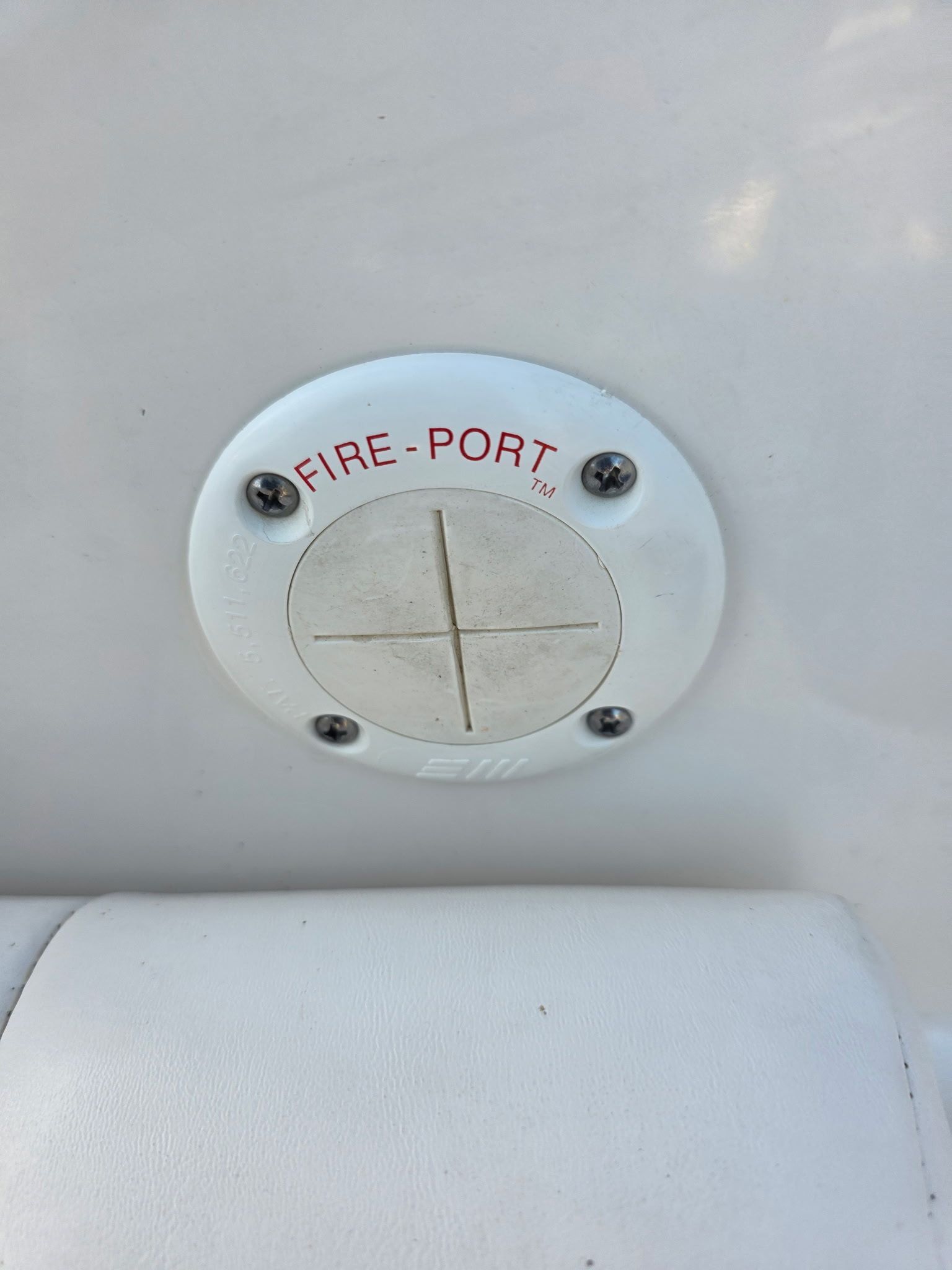 Close-up of a white fire port on a boat.