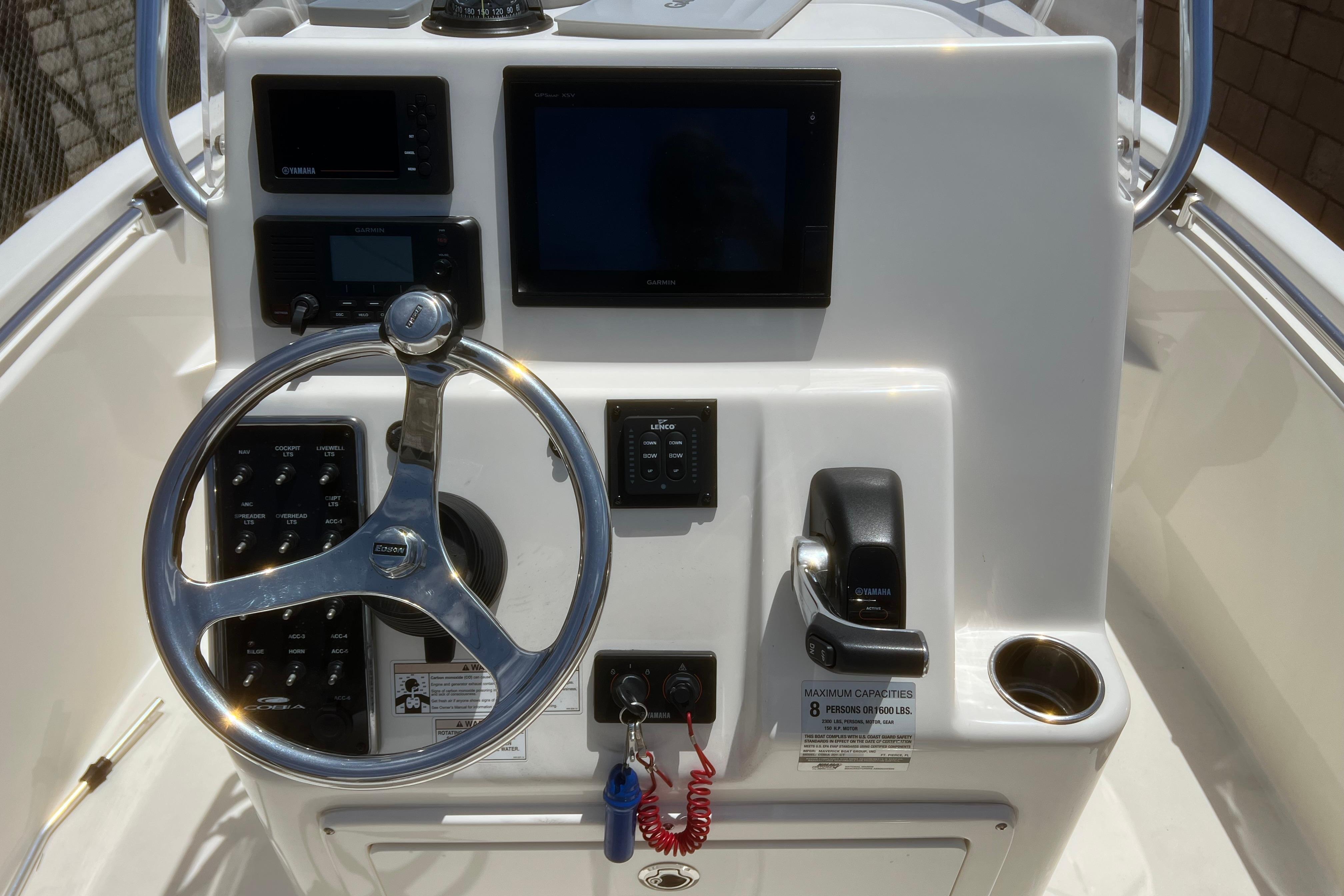 Center console of 2018 Cobia 201, featuring steering wheel and control panel.