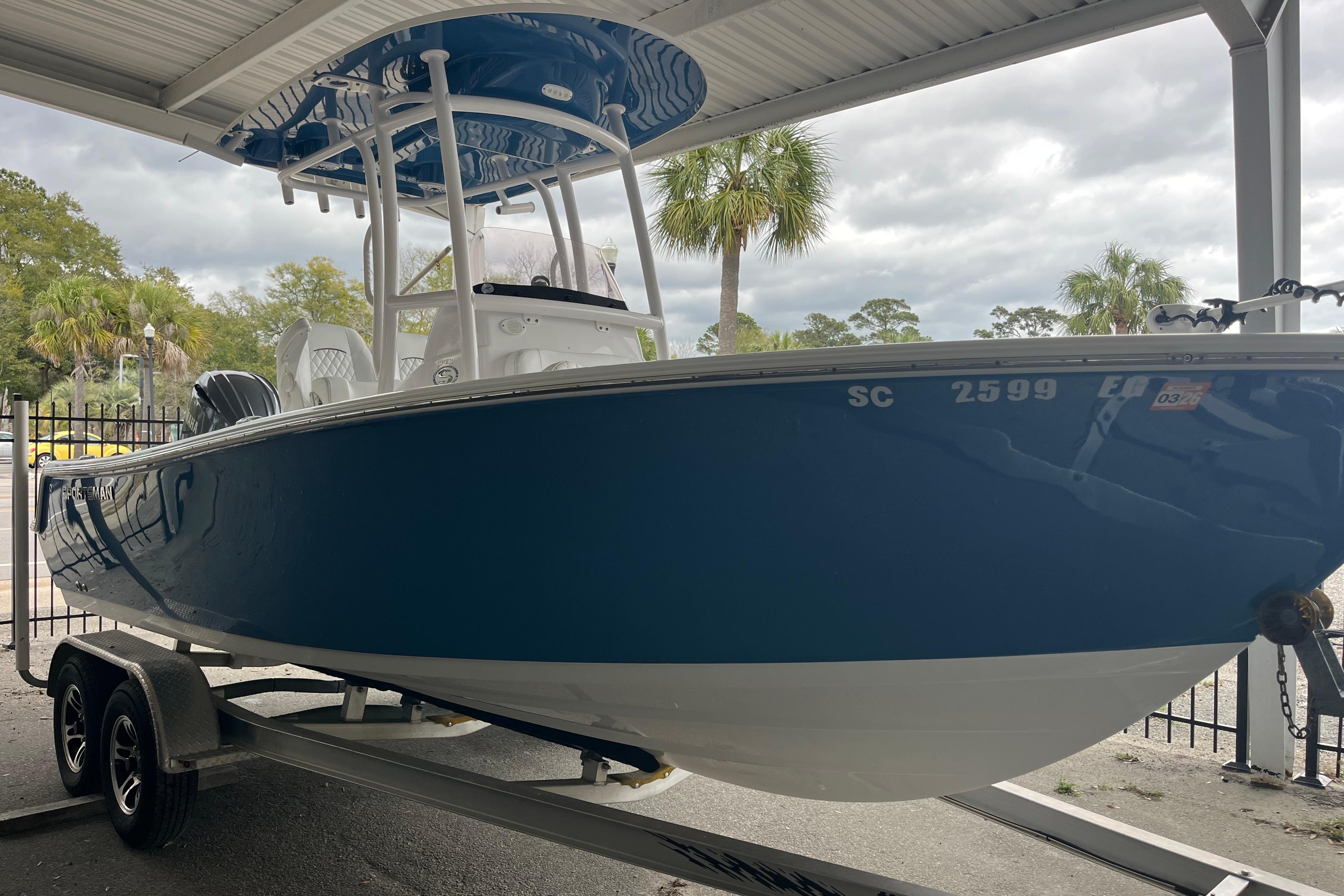 2024 Sportsman Open 212 Center Console boat on trailer under shelter.