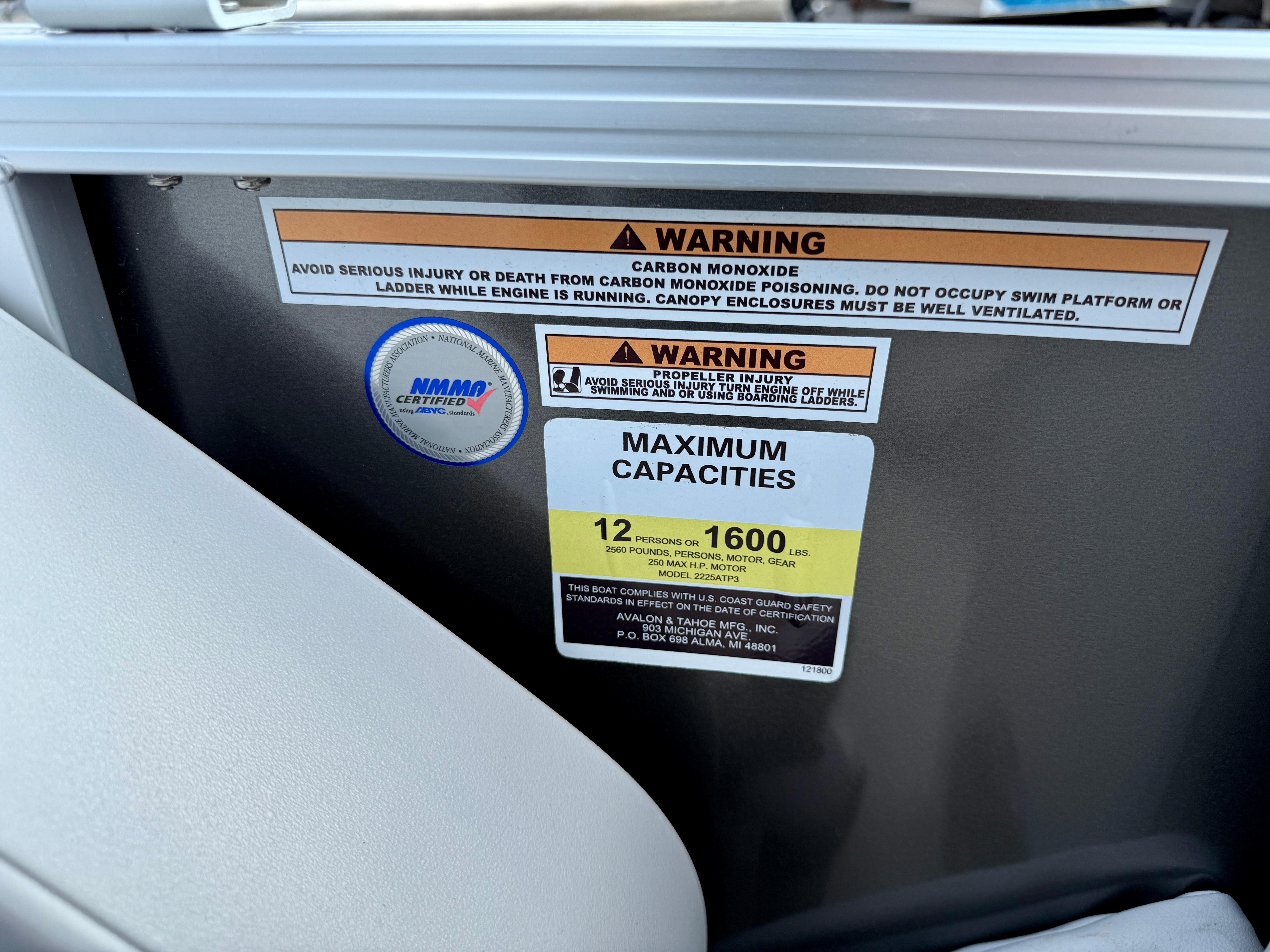 Warning labels and capacity limits on 2025 Avalon LSZ Cruise Rear Bench boat.