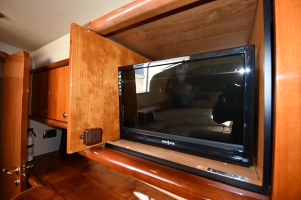 1997 Sunseeker Camargue 47 interior with built-in TV and wooden cabinetry.
