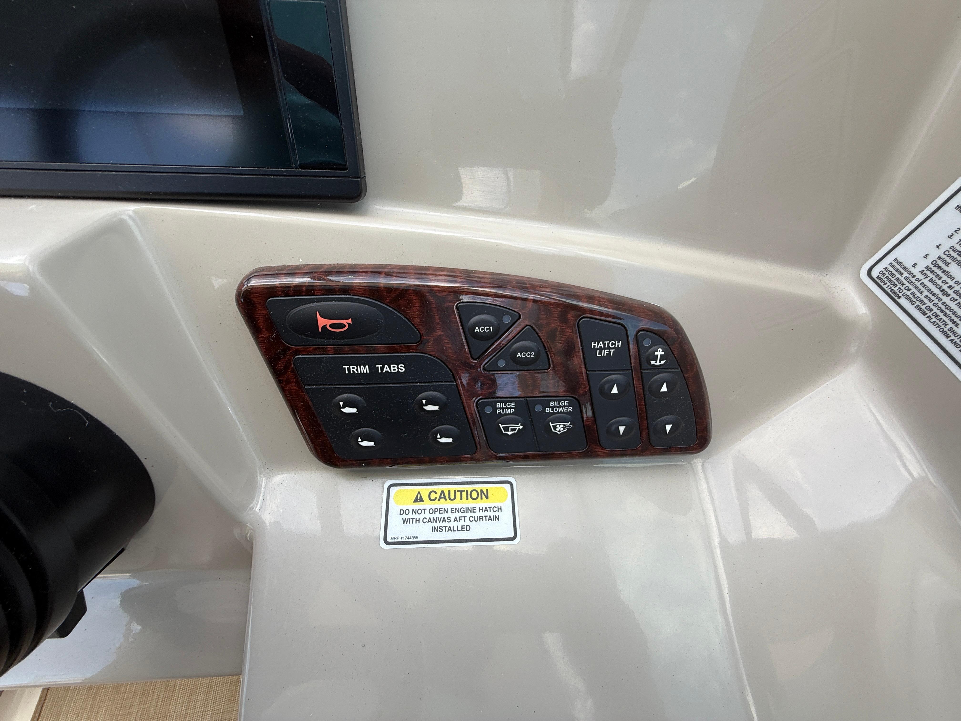 Control panel of a 2006 Sea Ray 290 Sundancer boat with various switches.