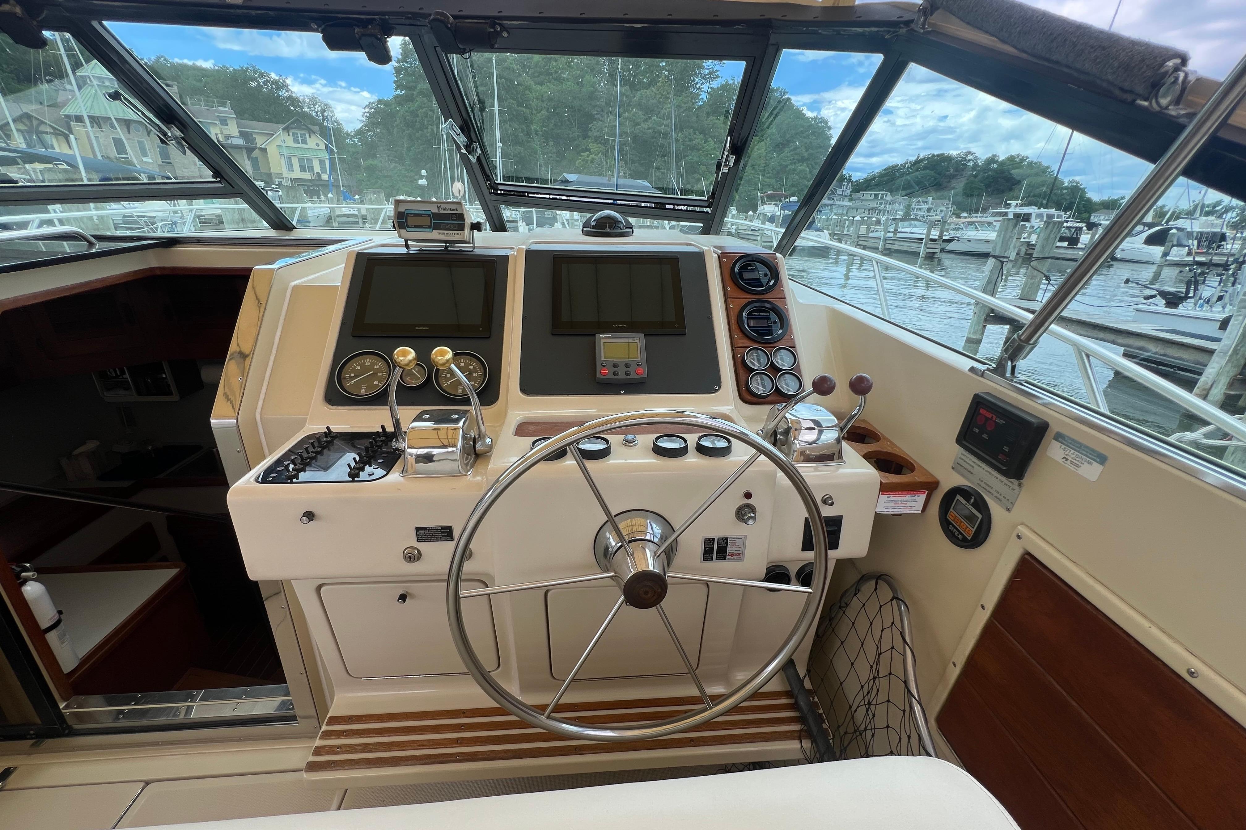 Helm of 1985 Tiara 36 OPEN boat with steering wheel and navigation instruments.