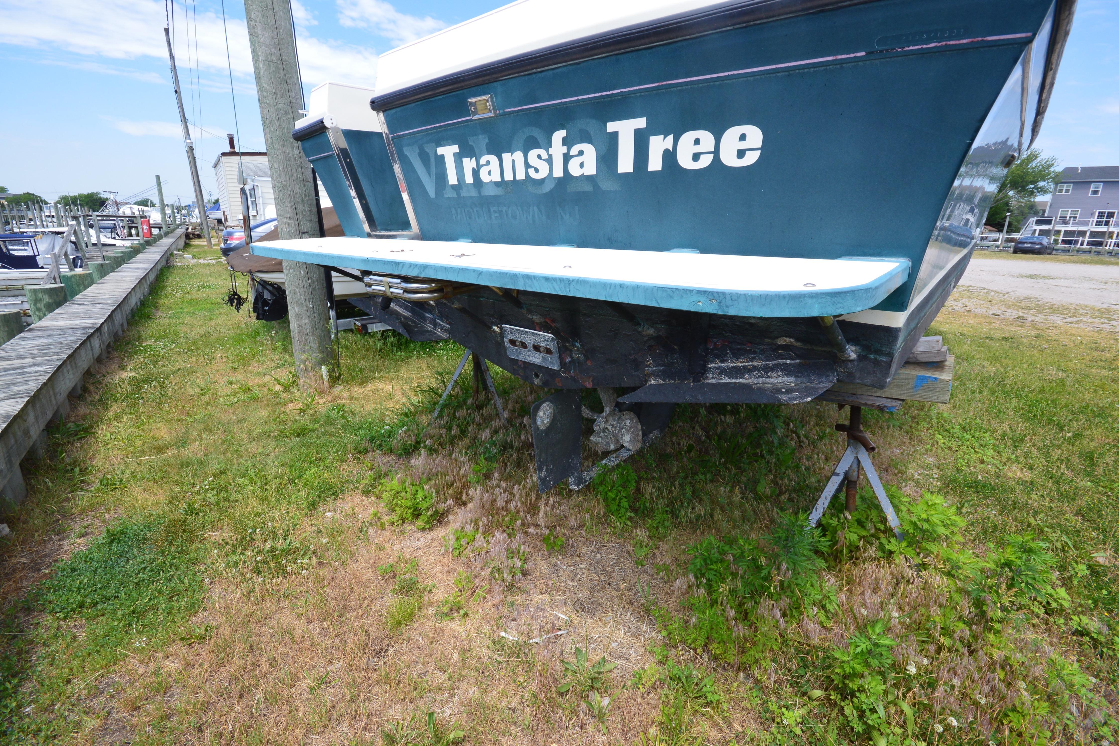 2001 Albin 28 Tournament Express boat on grass, rear view with visible propeller.