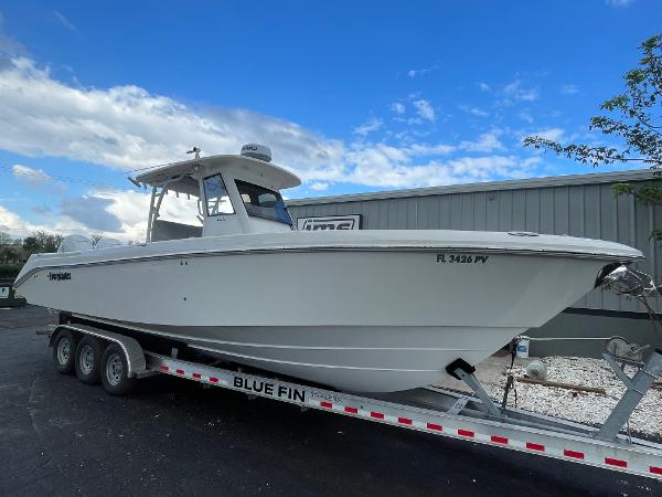 2014 Everglades 325 Center Console boat on trailer, parked outdoors.
