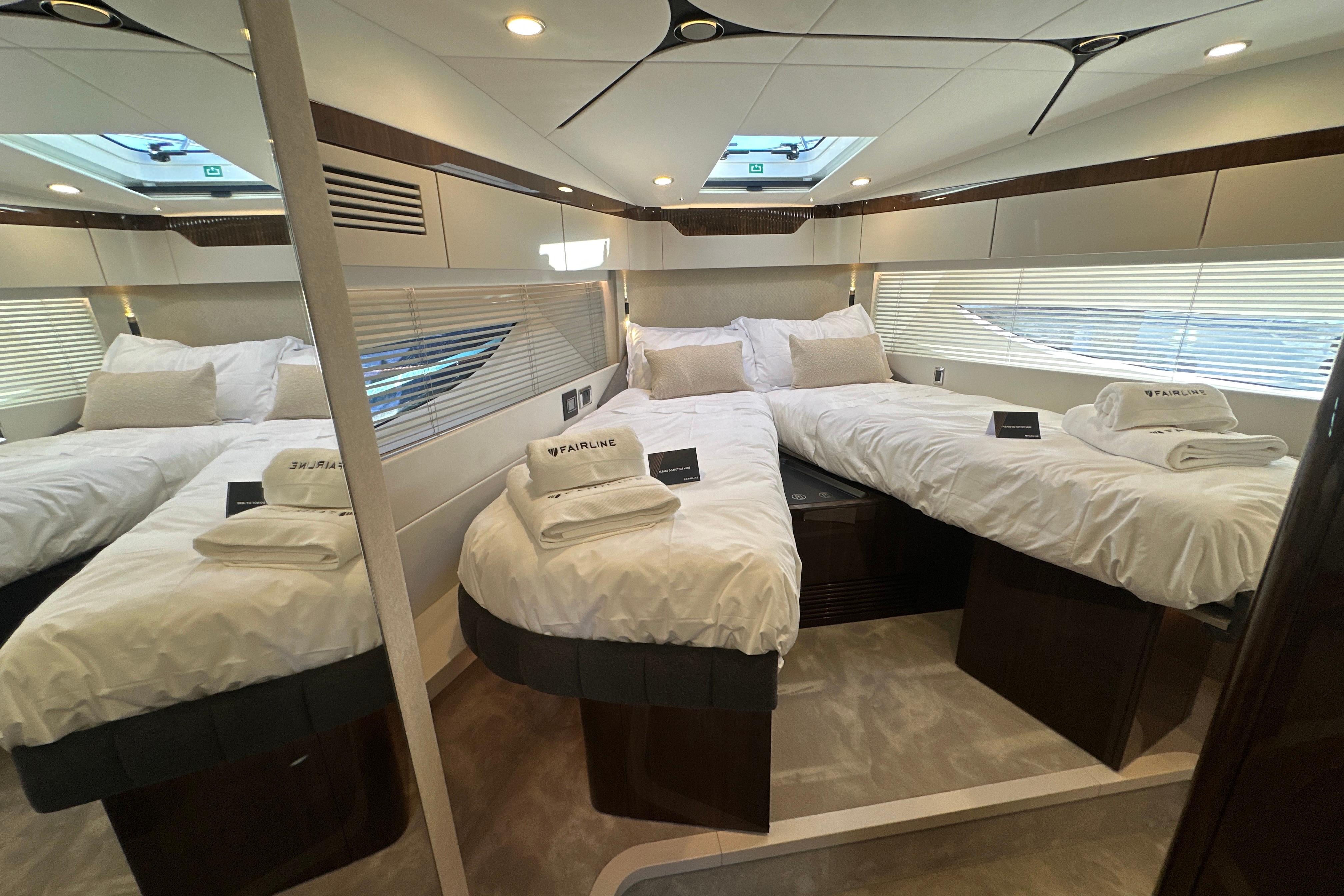 Luxurious cabin interior of 2026 Fairline Targa 47 GT yacht with twin beds.