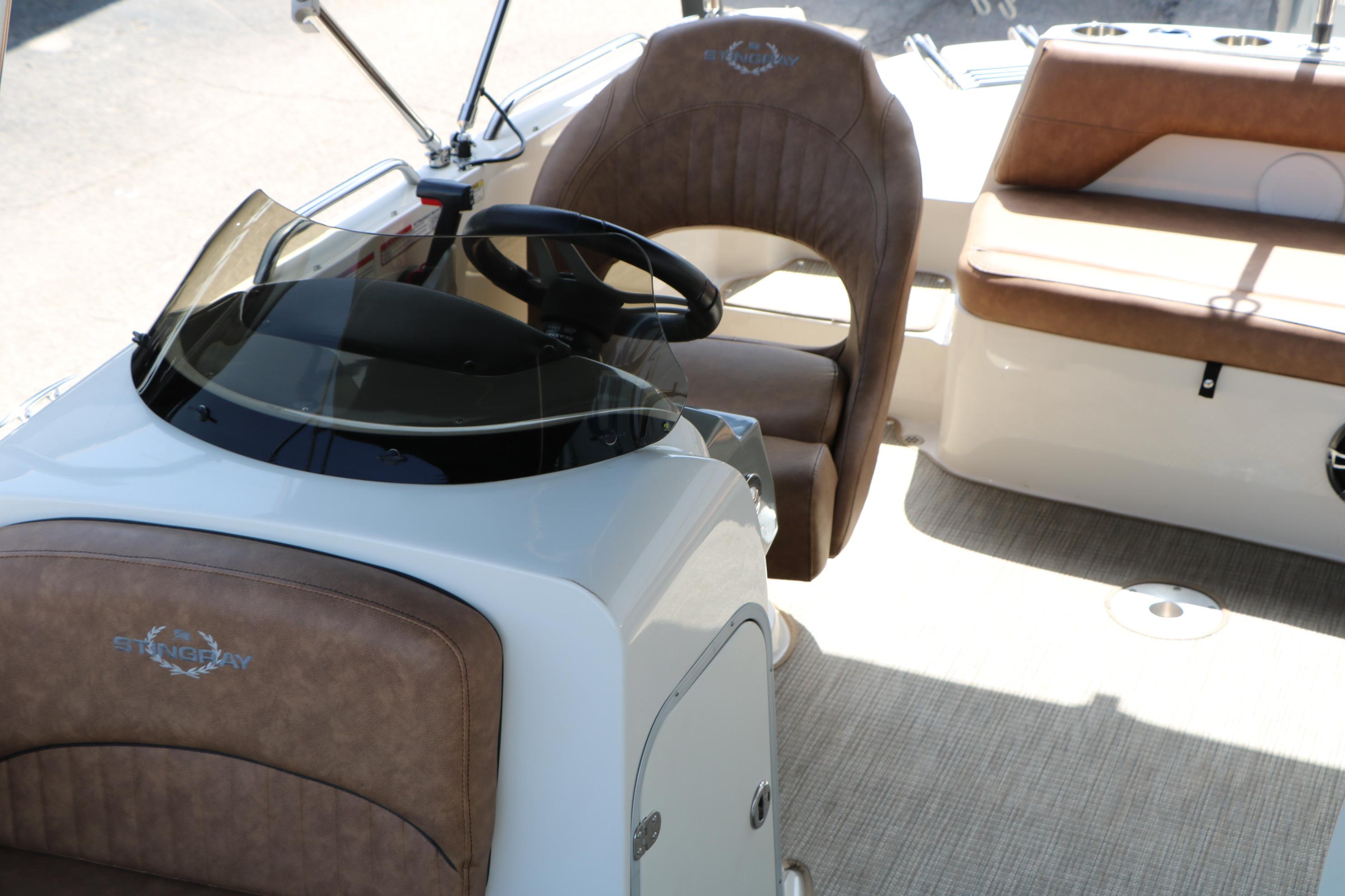 2022 Stingray 192 SC boat interior with brown seating and steering wheel.