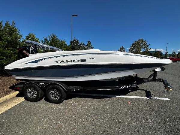 2023 Tahoe 1950 boat on a trailer in a parking lot.