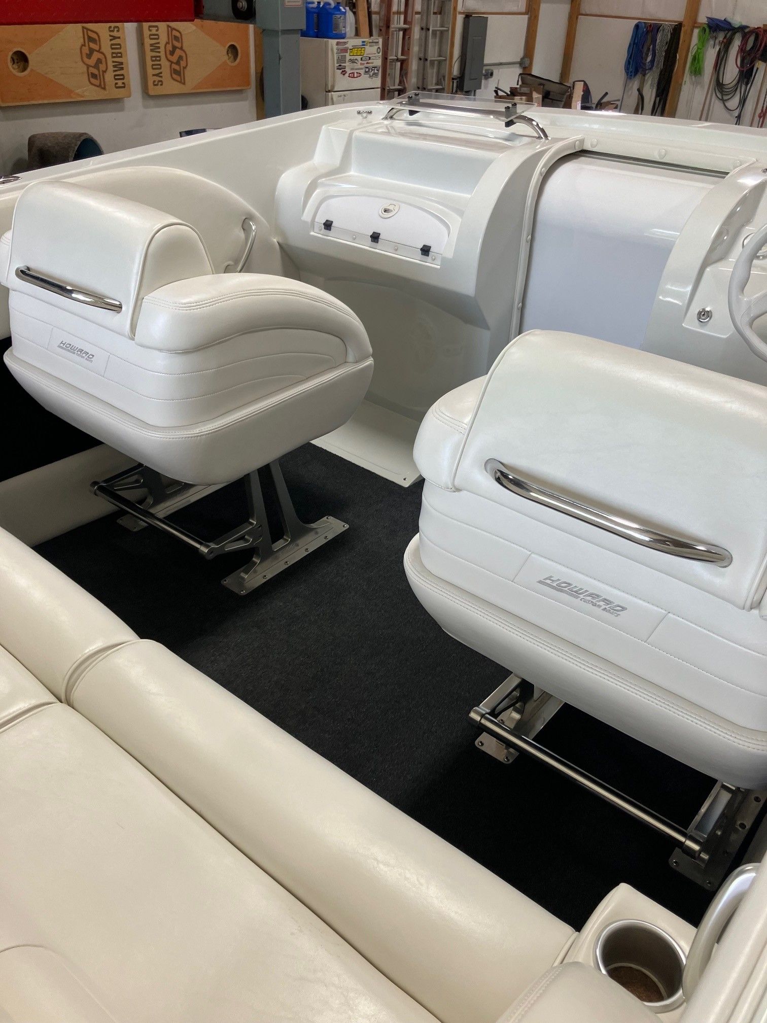 Interior of a 2003 Howard Bullet boat with white leather seats.