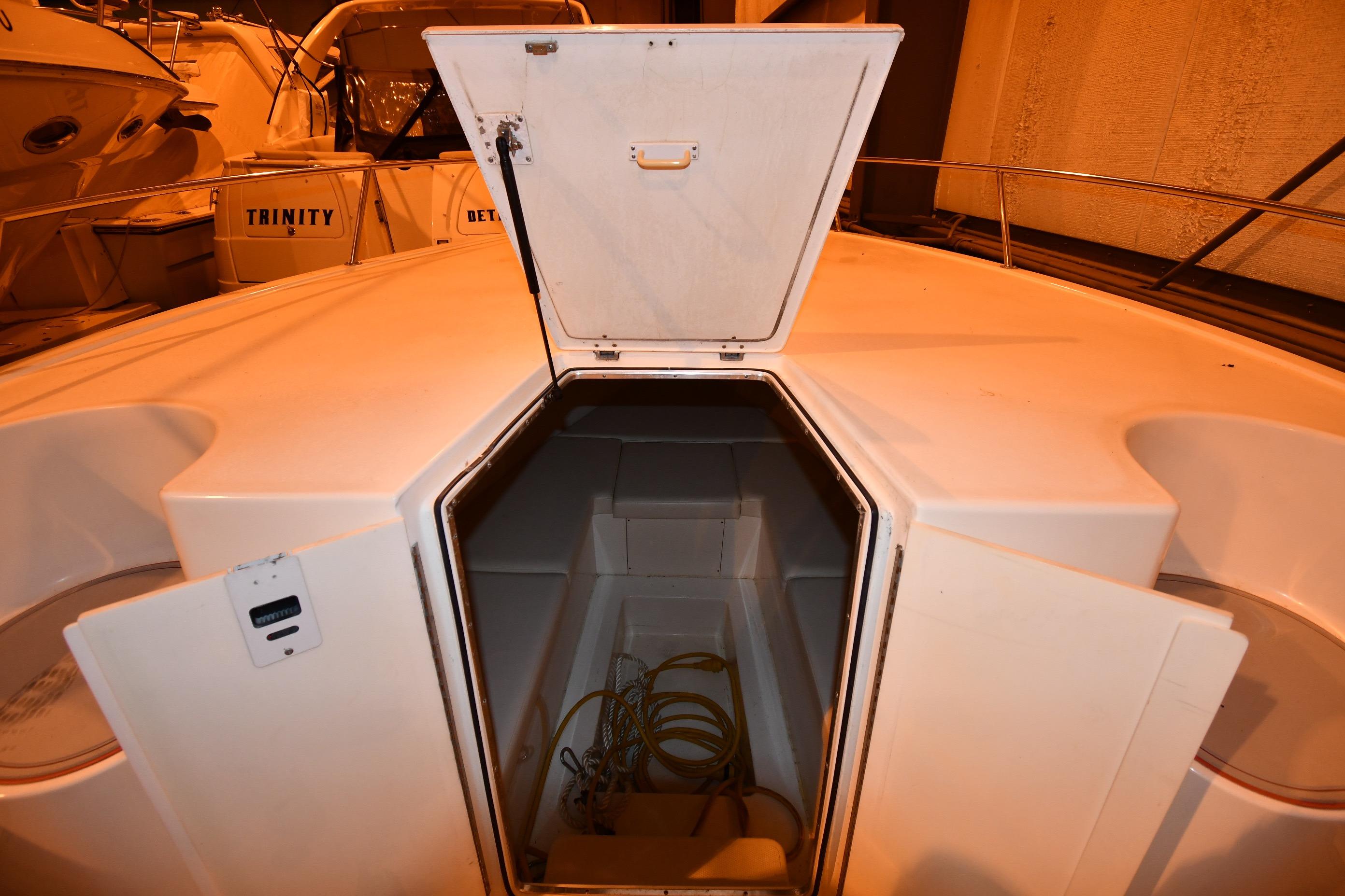 2001 Fountain 38 Center Console boat with open storage compartment.