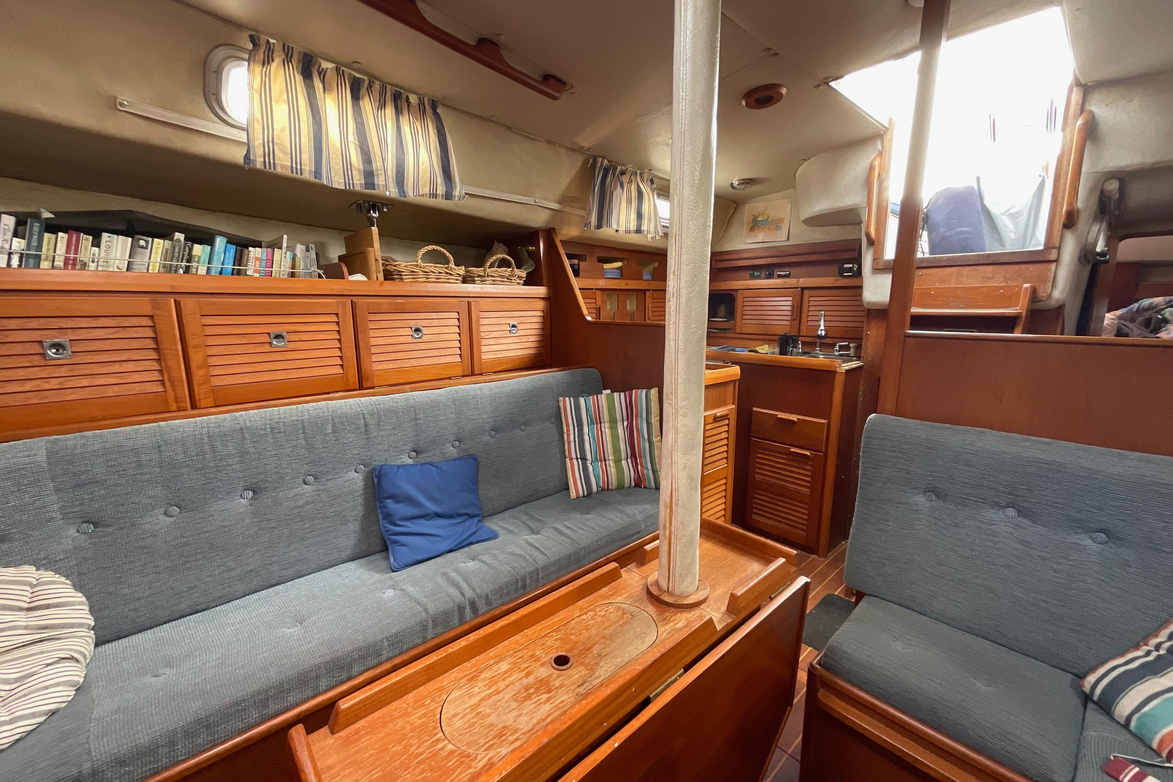 Interior of 1988 Westerly Corsair 36 sailboat with cozy seating and wooden cabinetry.