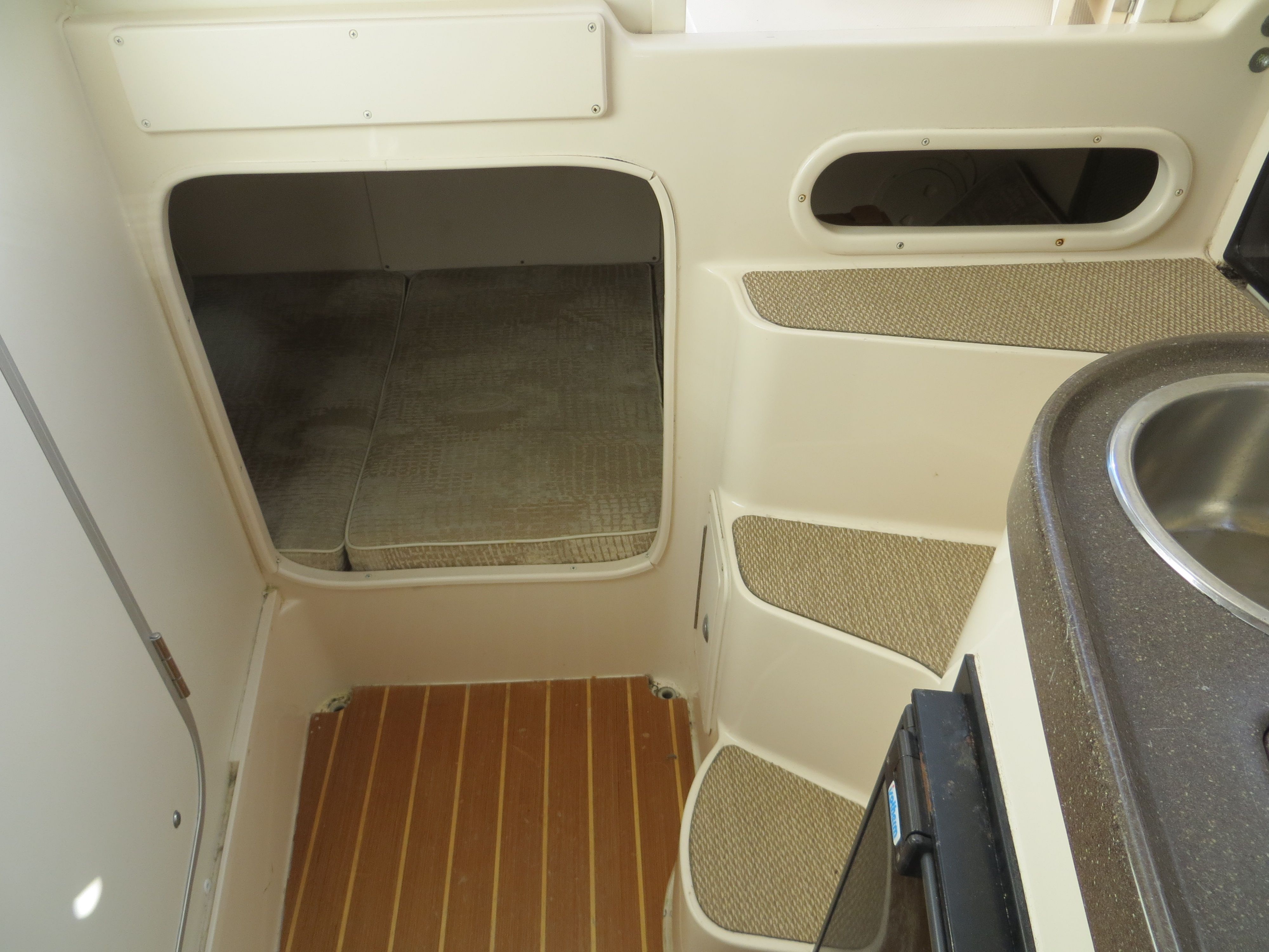 Interior of a 2007 Grady-White Sailfish 282 with carpeted flooring and a sink.