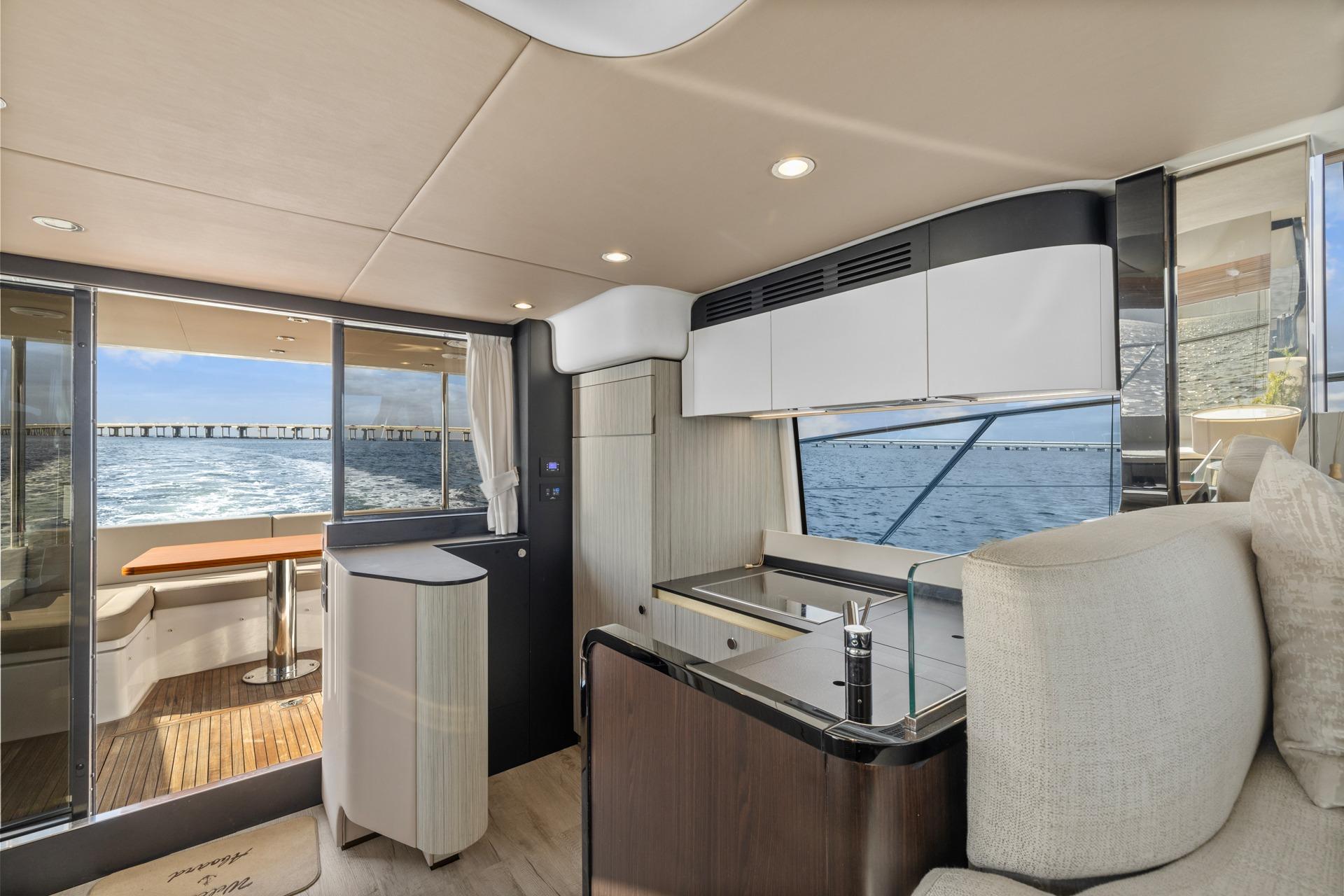 Luxurious interior of 2019 Azimut 55 yacht with modern kitchen and ocean view.