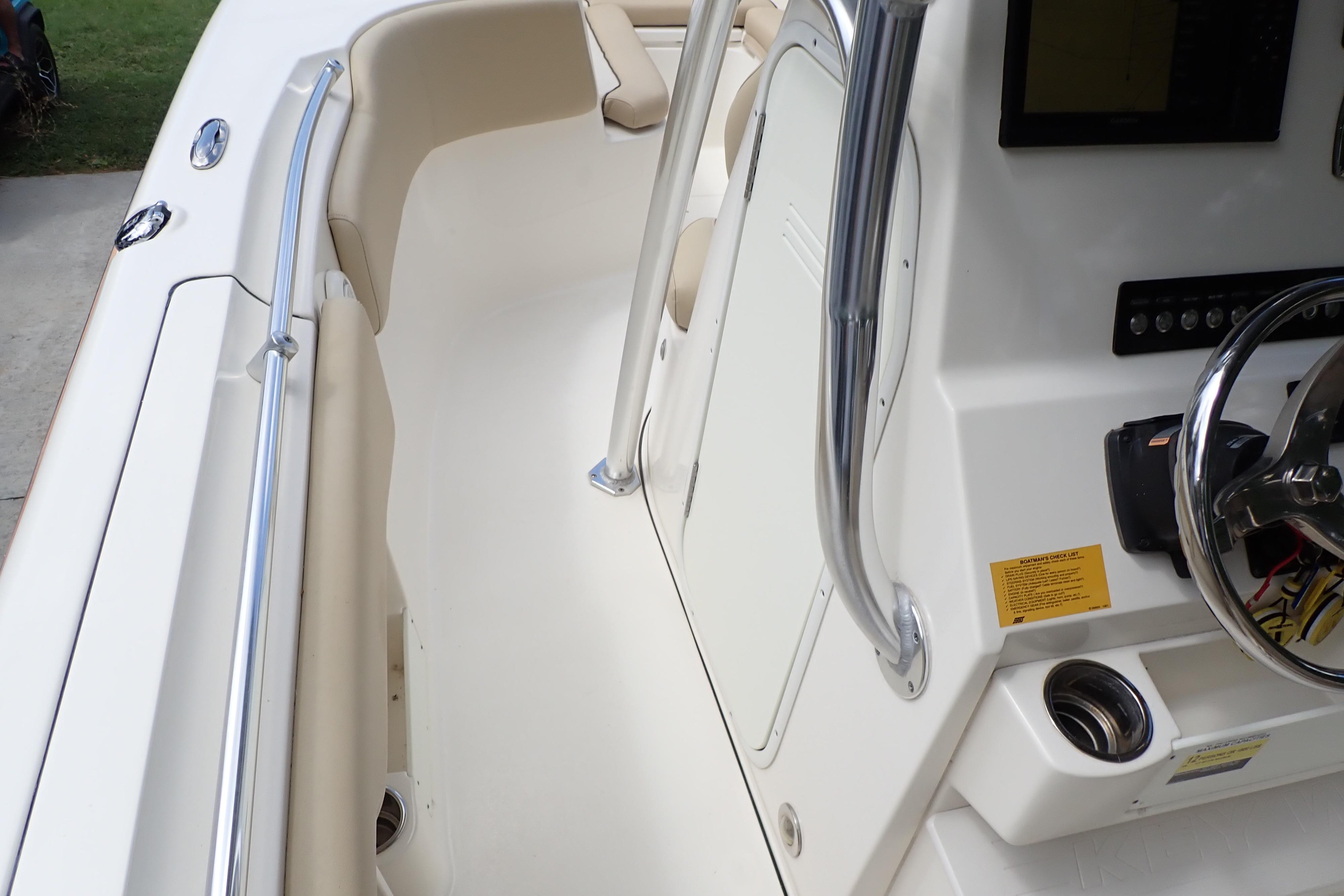 2019 Key West 263 FS boat interior with steering console and seating area.