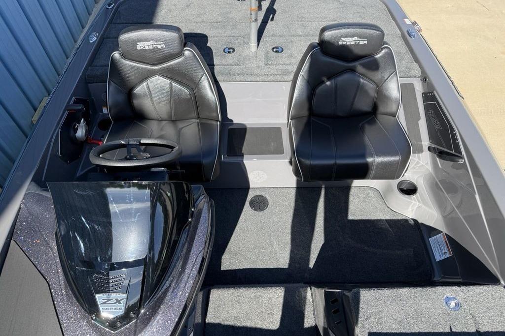 2026 Skeeter ZX150 boat interior with black leather seats and steering wheel.