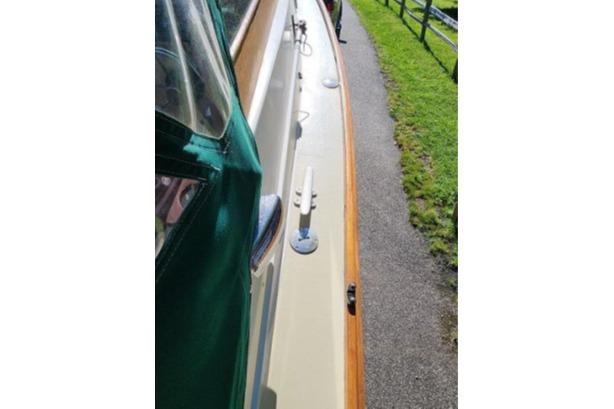 1985 Wasque Down East Cruiser docked, showcasing deck and railing details.