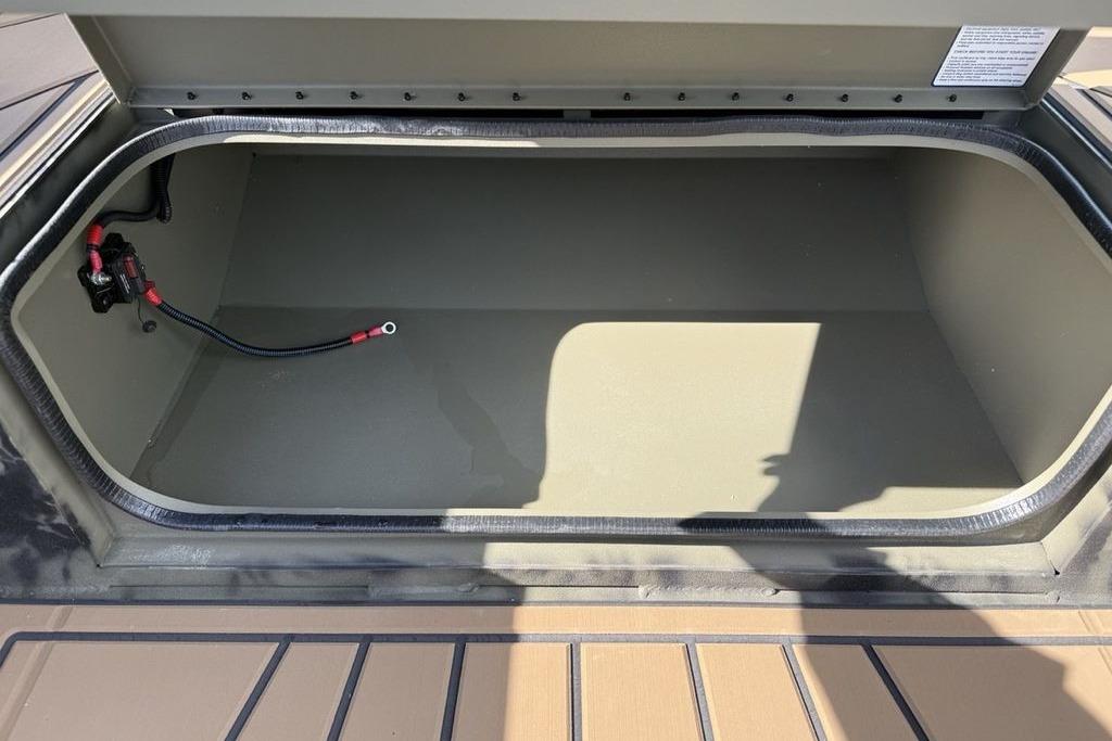 Open storage compartment of 2026 Tracker Grizzly 1650 T Prairie Wings Edition boat.