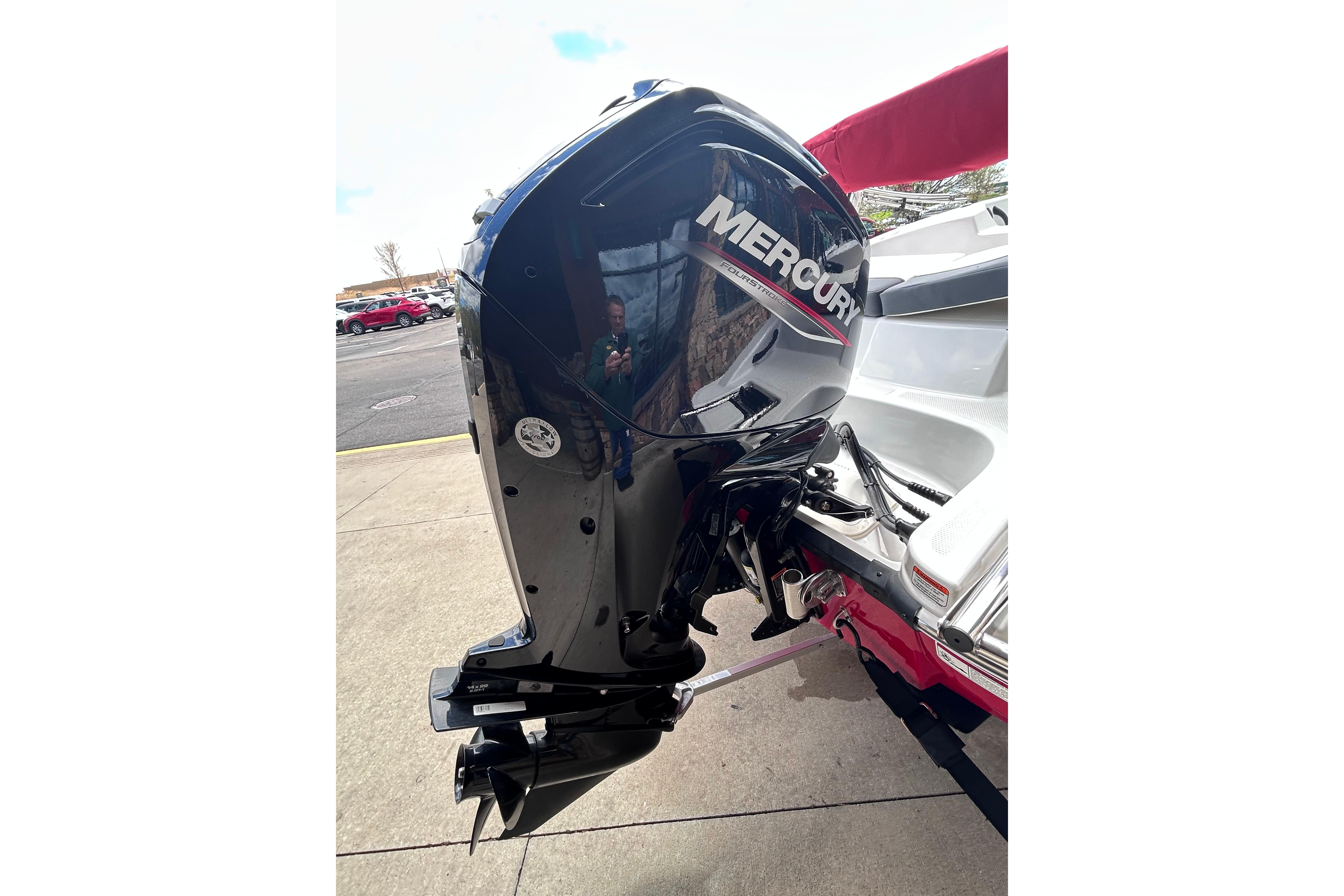 2026 Tahoe T16 boat with Mercury outboard motor, parked on pavement.